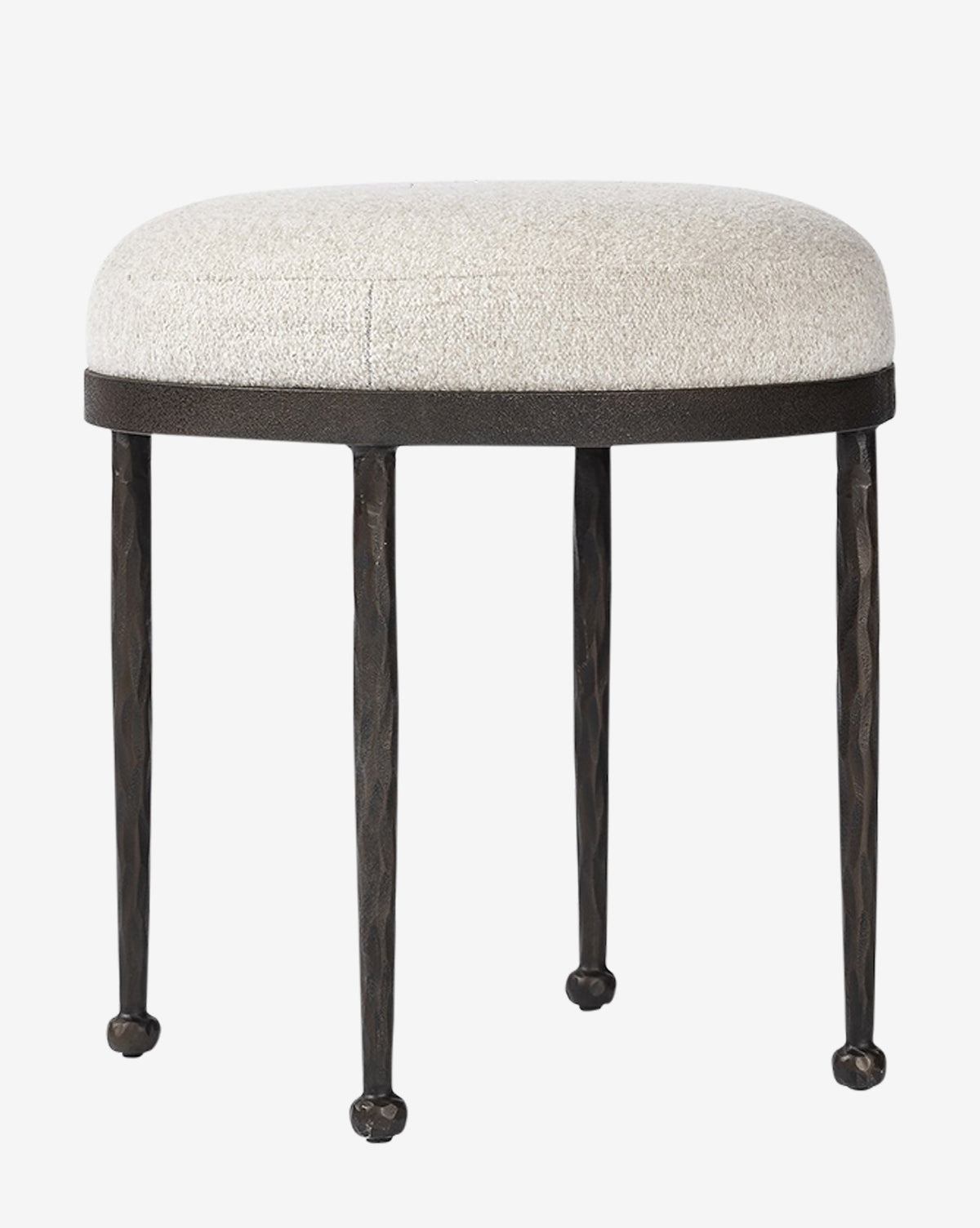 The Emmett Stool by Four Hands features a small hammered bronze frame, a round light cushioned seat, and slender black metal legs with rounded feet—an ideal accent piece for any space. Vendixs