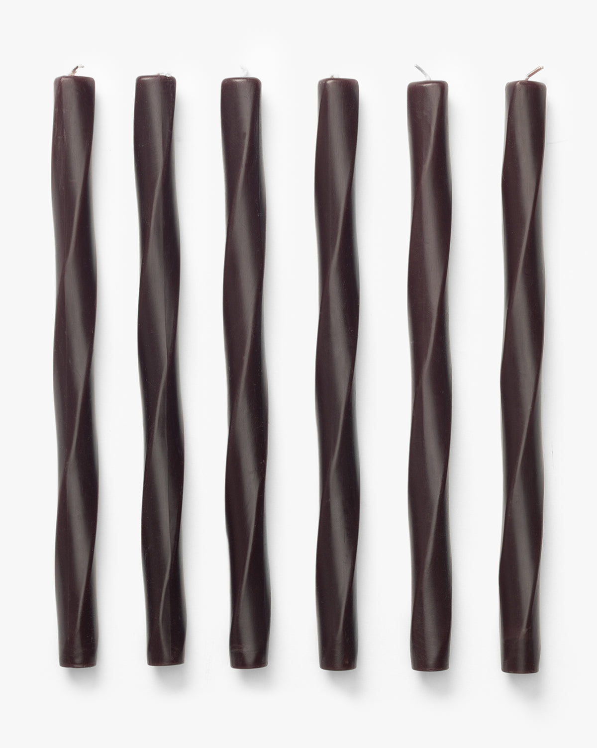 Six Errol Wax Tapers (Set of 6) in dark brown, featuring sculptural twisted designs, are arranged vertically in a row on a plain white background, by Vendixs