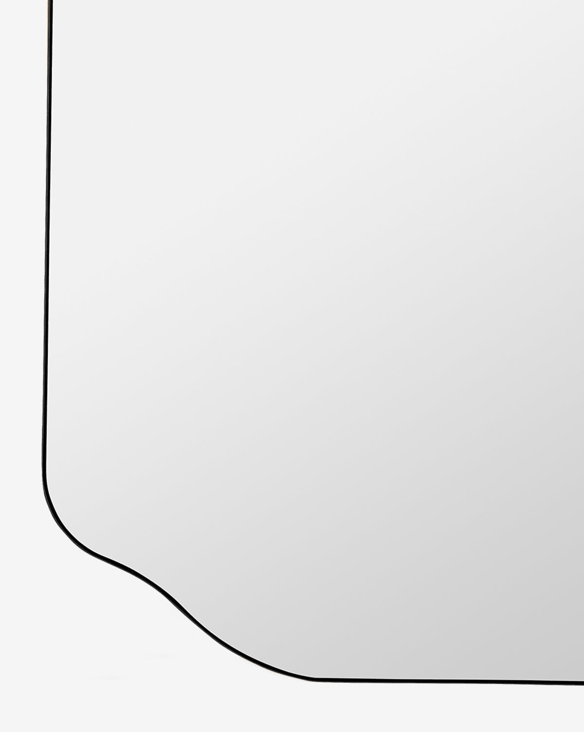 A close-up of the Ethel Wall Mirror, featuring an elegant black metal frame with a decorative curved edge, set against a plain white background, by Vendixs