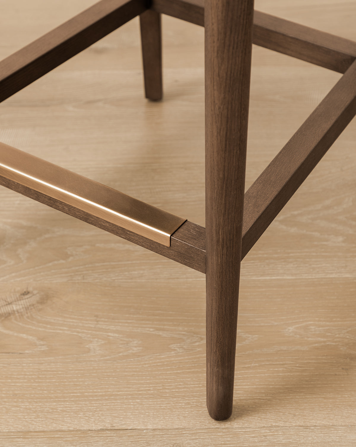 Certainly! Here’s how you can blend the exact string Vendixs into your description, placing it at the end as requested: Close-up of the Makerspalm Etienne Stool (Ready to Ship), showing its wooden leg with a brass footrest on light wood flooring. This stool blends vintage inspiration with a modern, minimalist design featuring clean lines and smooth textures. Vendixs Let me know if you’d like the name incorporated differently within or formatted in another way!.