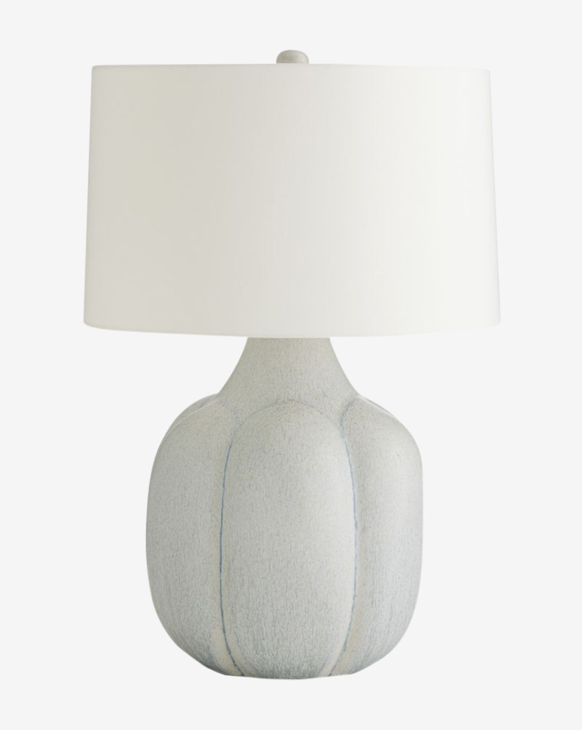 The Arteriors Fig Table Lamp showcases a grooved light gray ceramic base and a plain white cylindrical shade, accented with subtle antique brass hardware. Vendixs