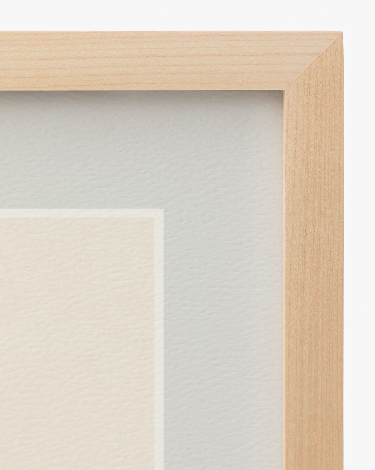 Close-up of the top right corner of the Finn wooden picture frame with light wood grain, part of a white mat, and textured Scottish Terrier sketch wall art beneath glass by Vendixs