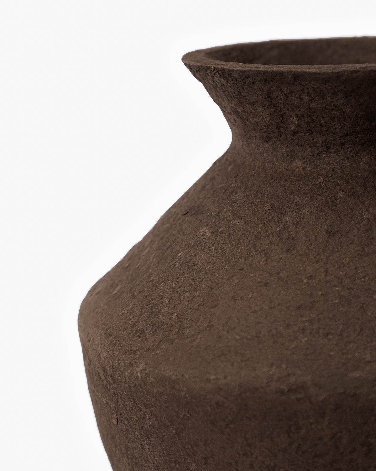 Close-up of the Frederick Paper Mache Vase, a handmade piece with a textured brown finish, wide neck, and rounded body. Partially shown against a white background to highlight its rustic surface detail, by Vendixs