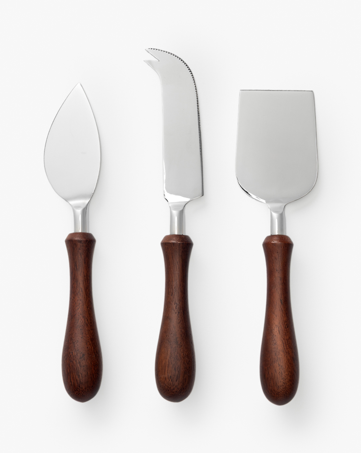 The Fromagerie Cheese Knives (Set of 3) features wooden handles and stainless steel blades: a pointed knife, a fork-tipped serrated knife, and a wide flat chisel—essential tools for entertaining on any occasion, by Vendixs