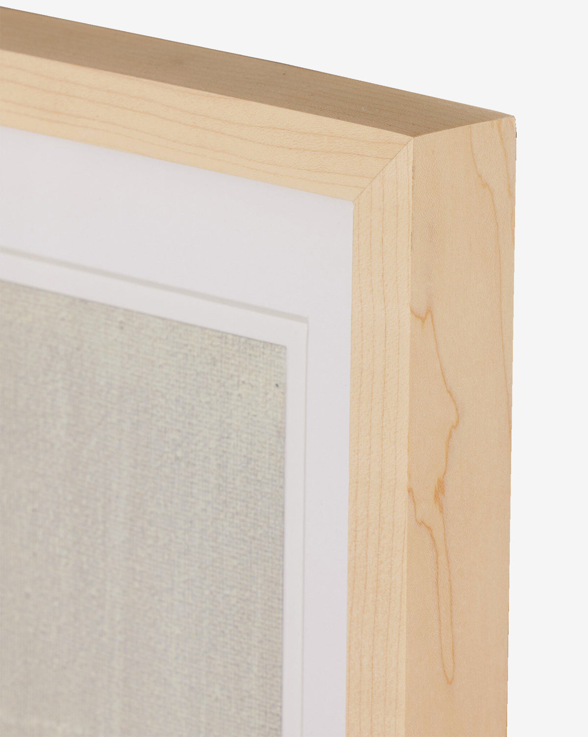 Close-up of a light wood picture frame with a white mat, highlighting Jade Dacays Galactic IV mixed media minimalist art, by McGee & Co. The textured artwork is partially visible against a plain white background.
