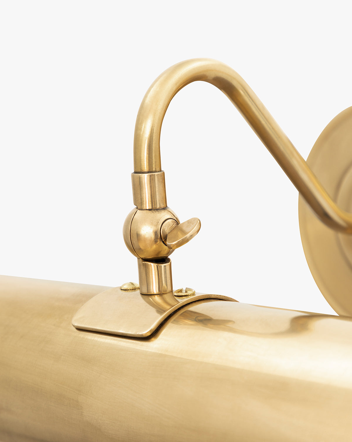 A close-up of the Gallery Picture Sconce in burnished bronze, showcasing its vintage-inspired design with a curved arm and adjustable joint, set against a plain white background, by Vendixs