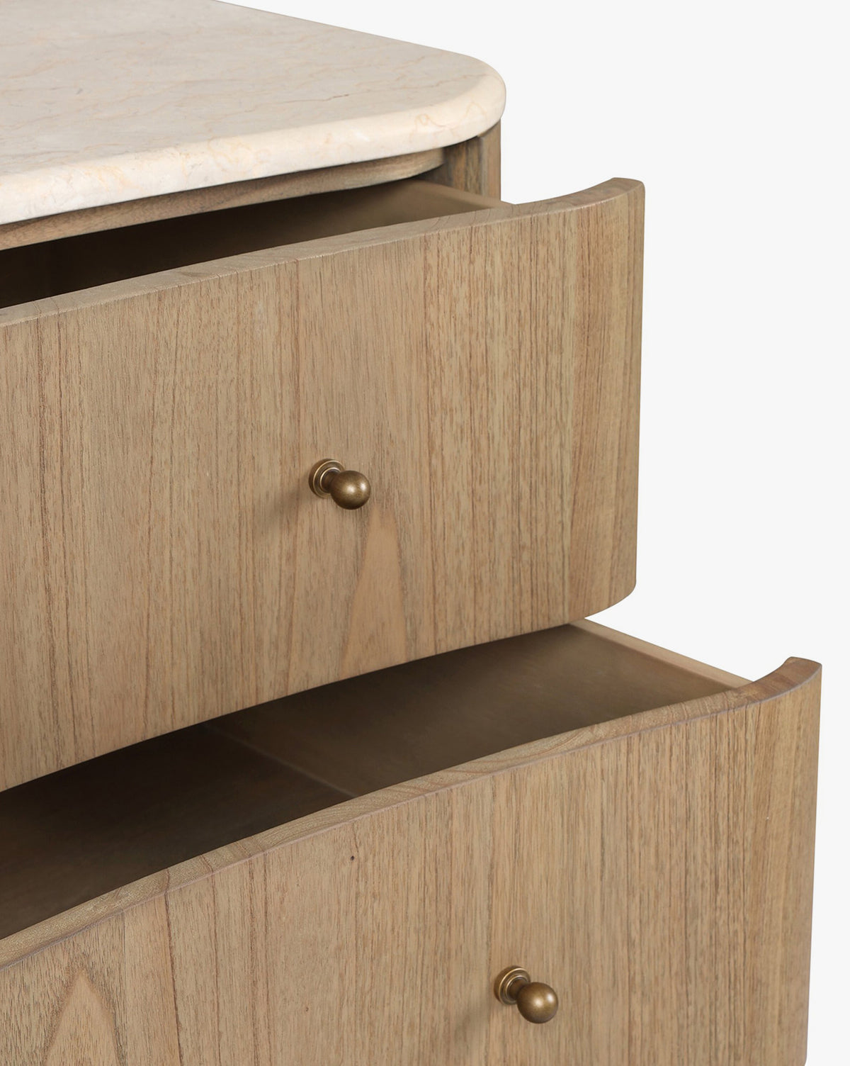 A close-up of the Gatlin Chest reveals its spacious drawers, light mindi wood finish, round brass knobs, and a smooth marble top, by Vendixs