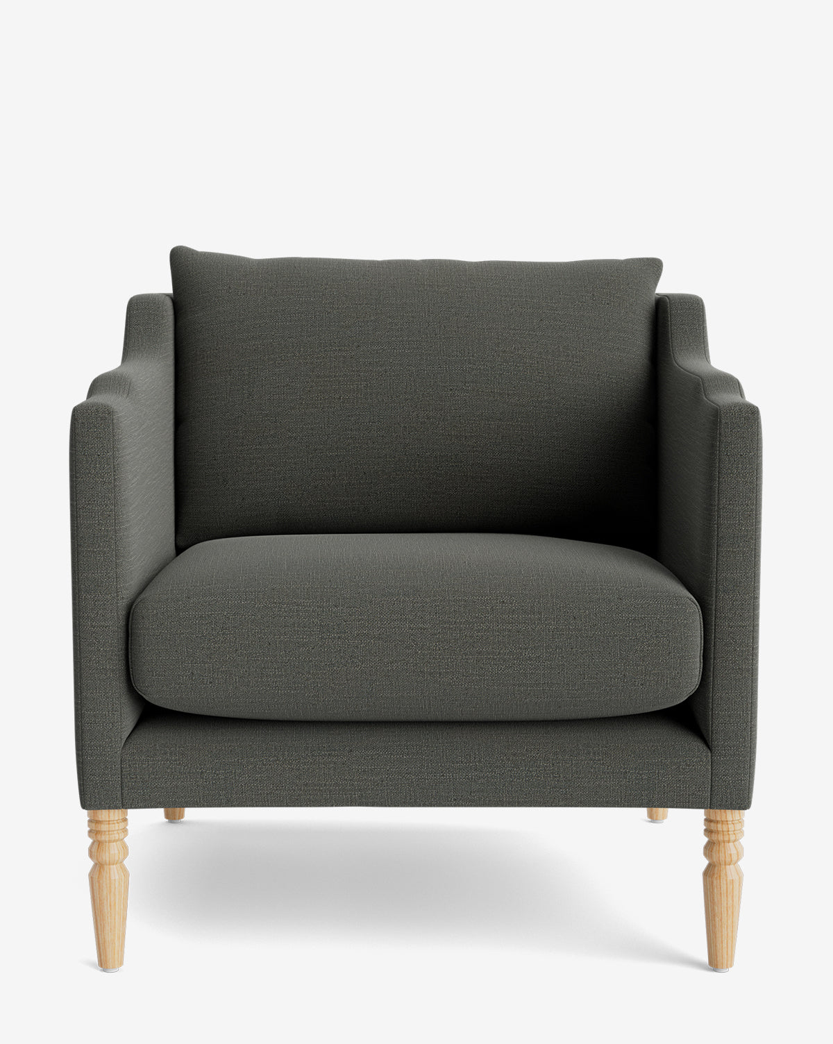 The Gemma Lounge Chair is a dark gray upholstered armchair featuring a boxy design, wide seat, and four light wood turned legs crafted from high-quality fabric, shown on a plain white background by McGee & Co.