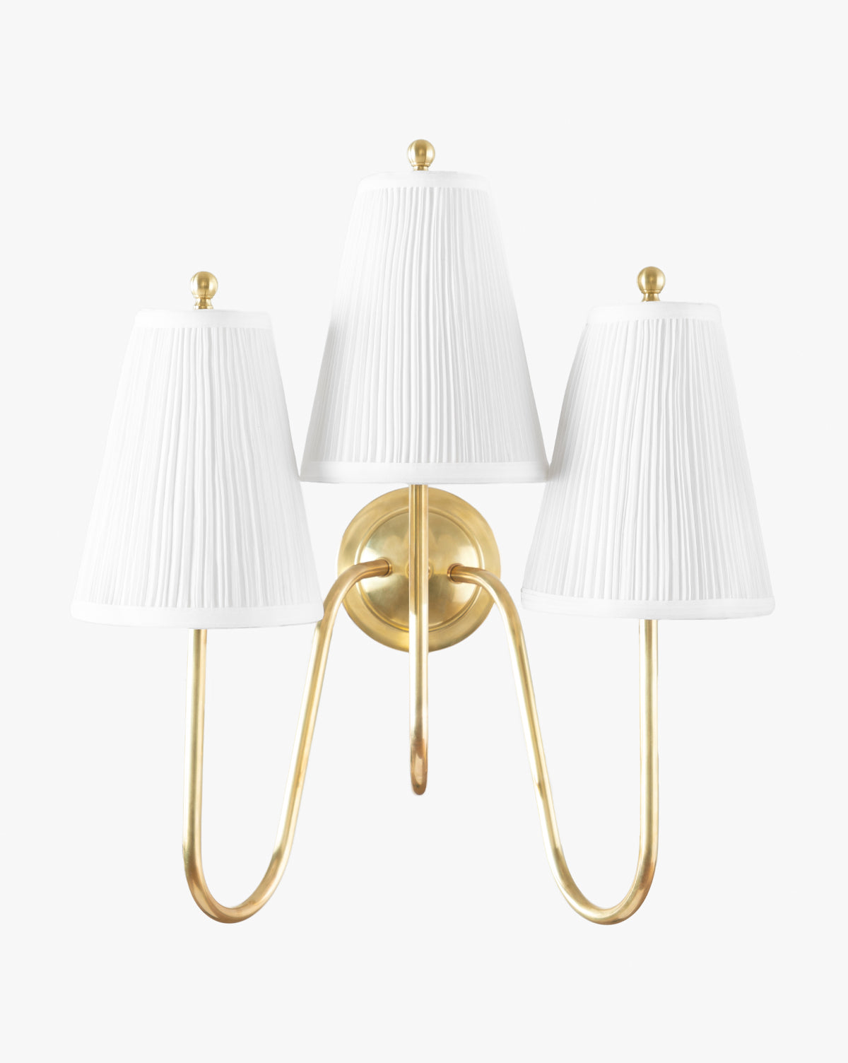 The Makerspalm Georgiana Triple Sconce showcases an antique brass finish with three curved arms and elegant linen pleated shades, all set against a plain white background. Vendixs