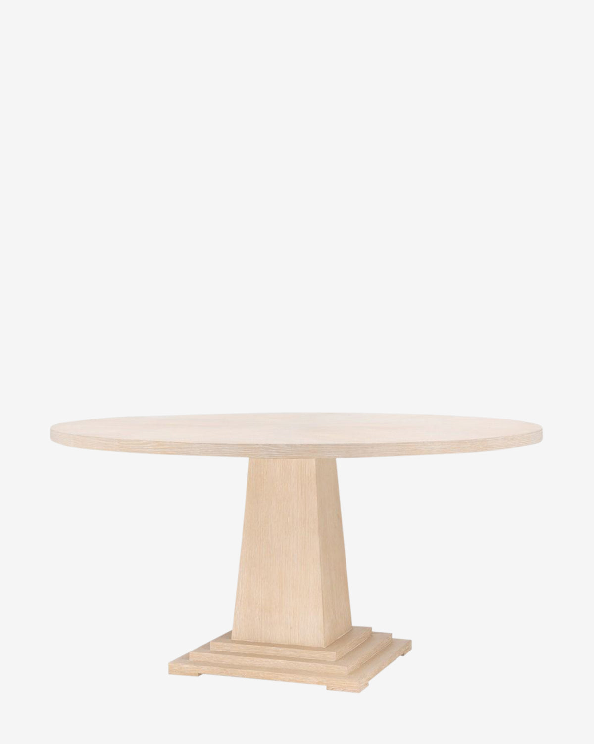 The Gideon Dining Table features a round light oak top, thick pedestal base, and stepped square platform, displayed against a plain white background by McGee & Co.