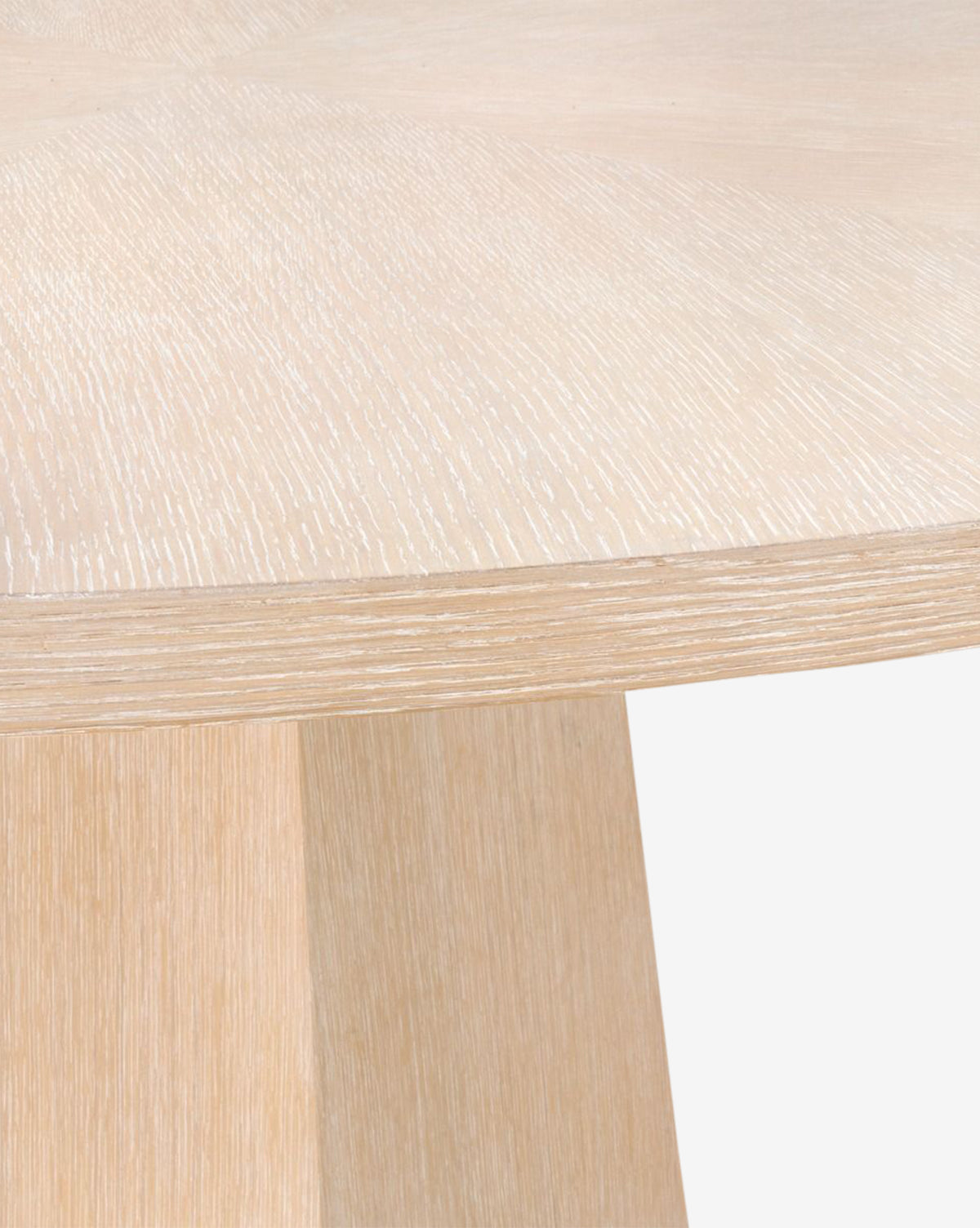 Close-up of the Gideon Dining Table, featuring a smooth light oak surface and visible wood grain, highlighting the tabletop and base edge against a plain white background by Vendixs