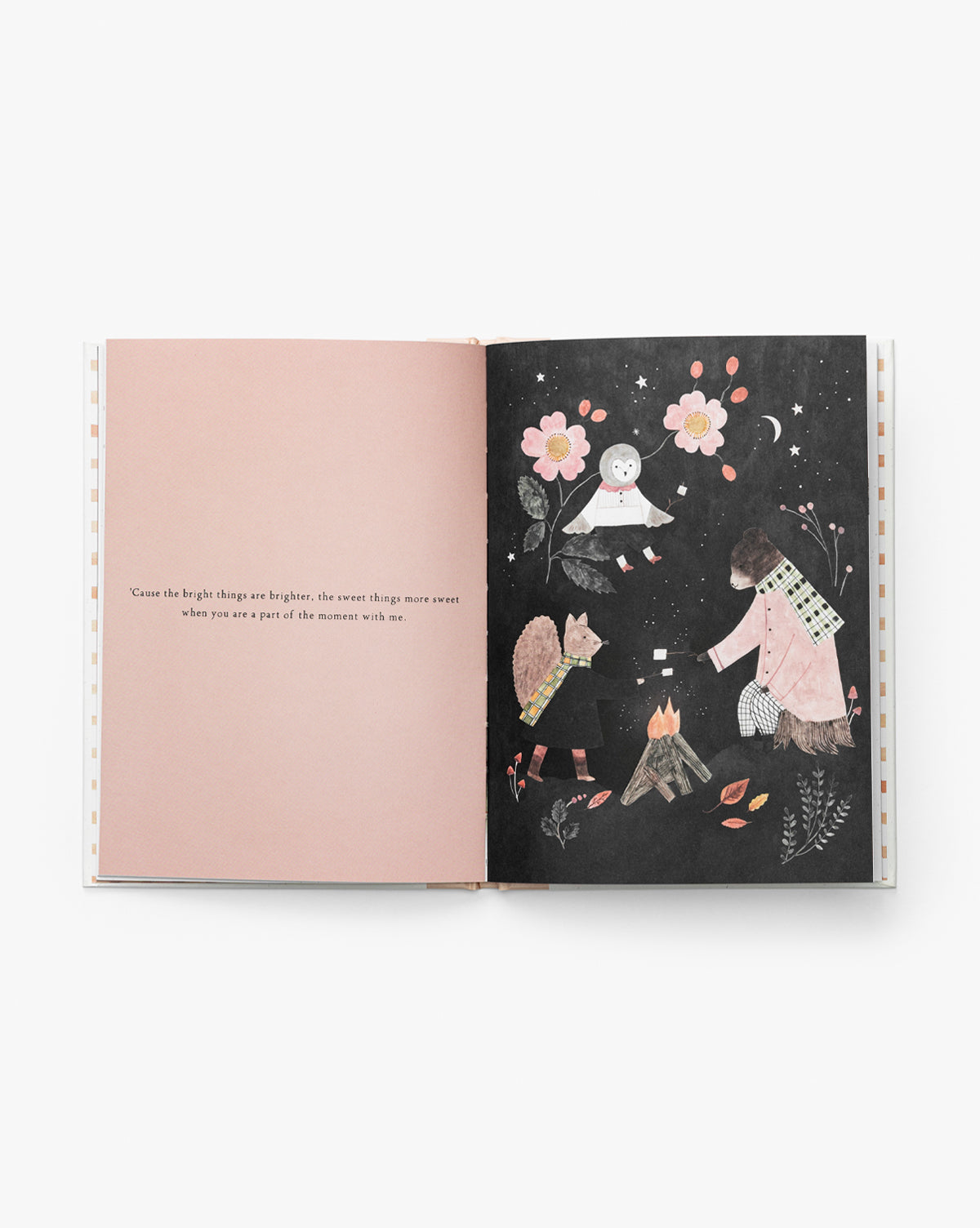 In Grateful for You, an open book reveals poetic writing on a pale pink left page, while the right page features three animals and a child gathered by a campfire at night, surrounded by flowers and stars by Vendixs