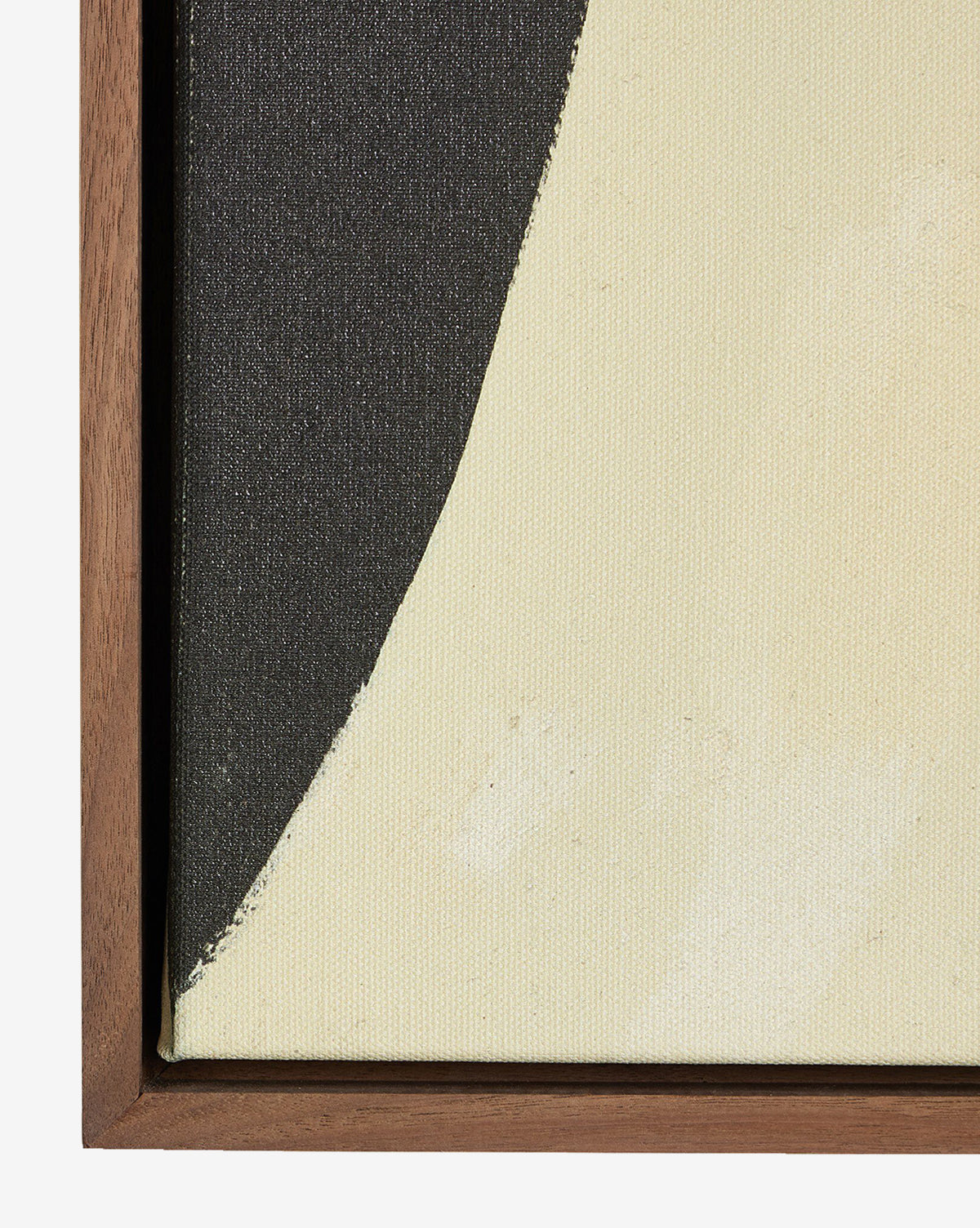 A close-up of Grecco I by Jess Engle, a framed abstract painting with a curved black shape on a light cream background, featuring a walnut gallery floater frame along the left and bottom edges for a modern accent, by Vendixs