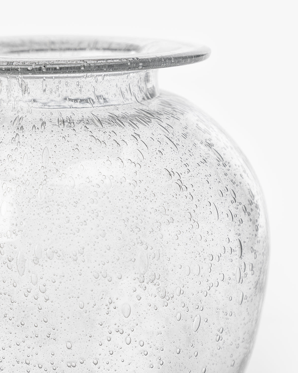 Close-up of the Gretchen Vase, showcasing its wide rim, rounded body, and numerous small air bubbles in the seeded glass, set against a plain white background, by Vendixs