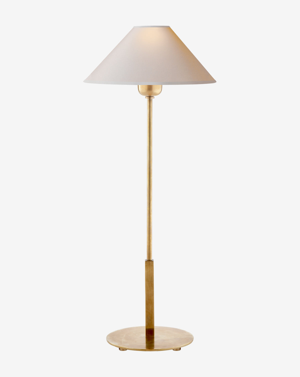 The Hackney Table Lamp features a slim brass body, a wide white linen shade, and stands on a round gold base, shown against a plain white background by Vendixs