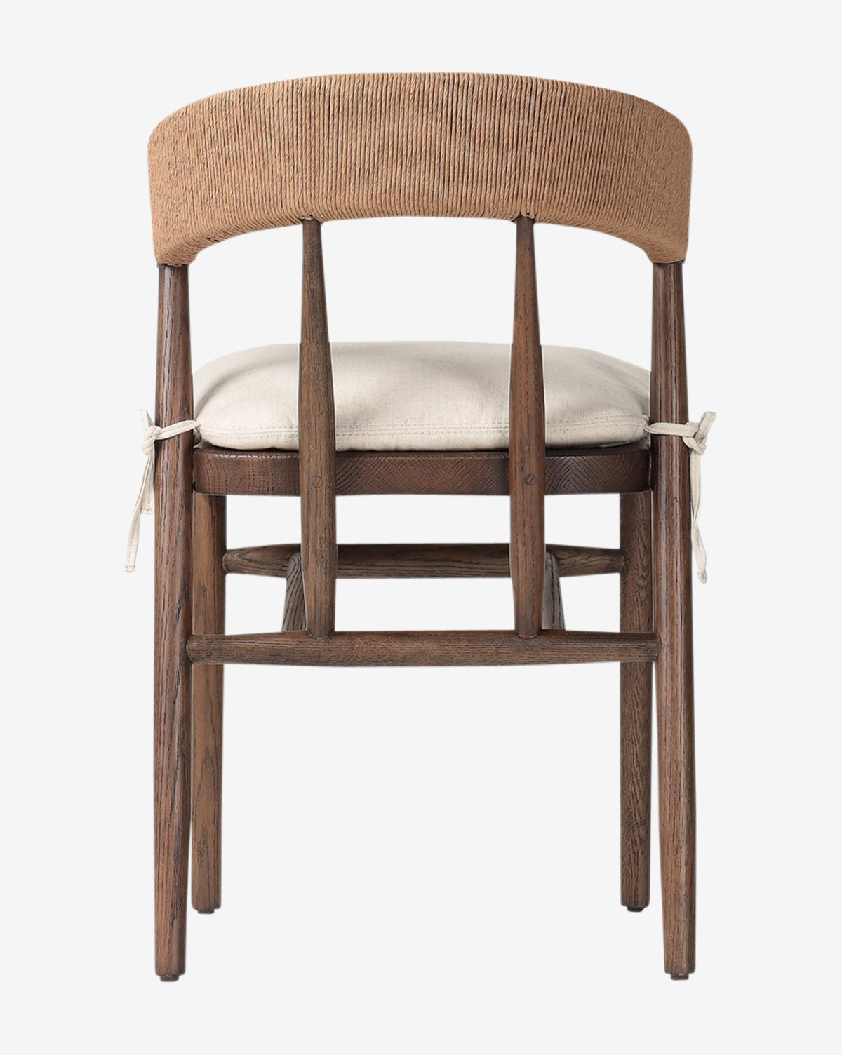 The Hallow Chair is a rustic dining chair with a curved, woven backrest and a light cushioned seat tied to its oak frame, shown from behind against a white background by Vendixs