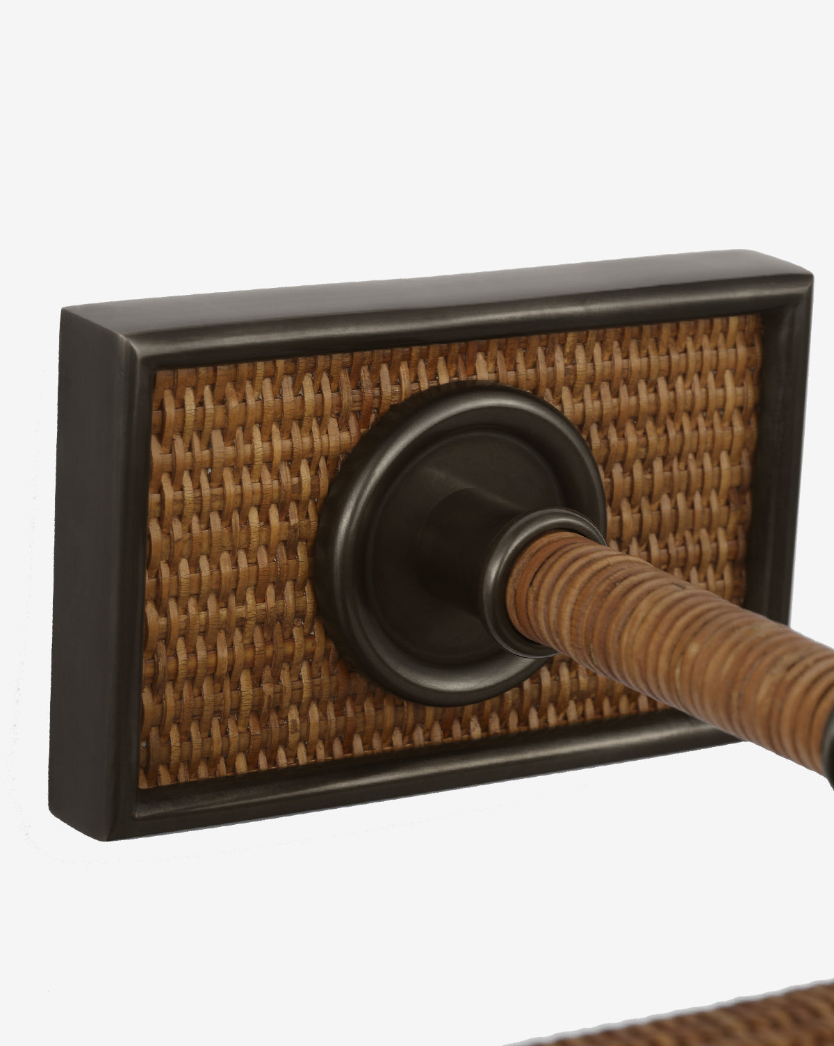 Close-up of the Halwell Picture Light: a door handle with a rectangular backplate featuring woven rattan and a dark metal border, attached to a rod in matching material—ideal for rooms enhanced by thoughtful artwork lighting, by Vendixs