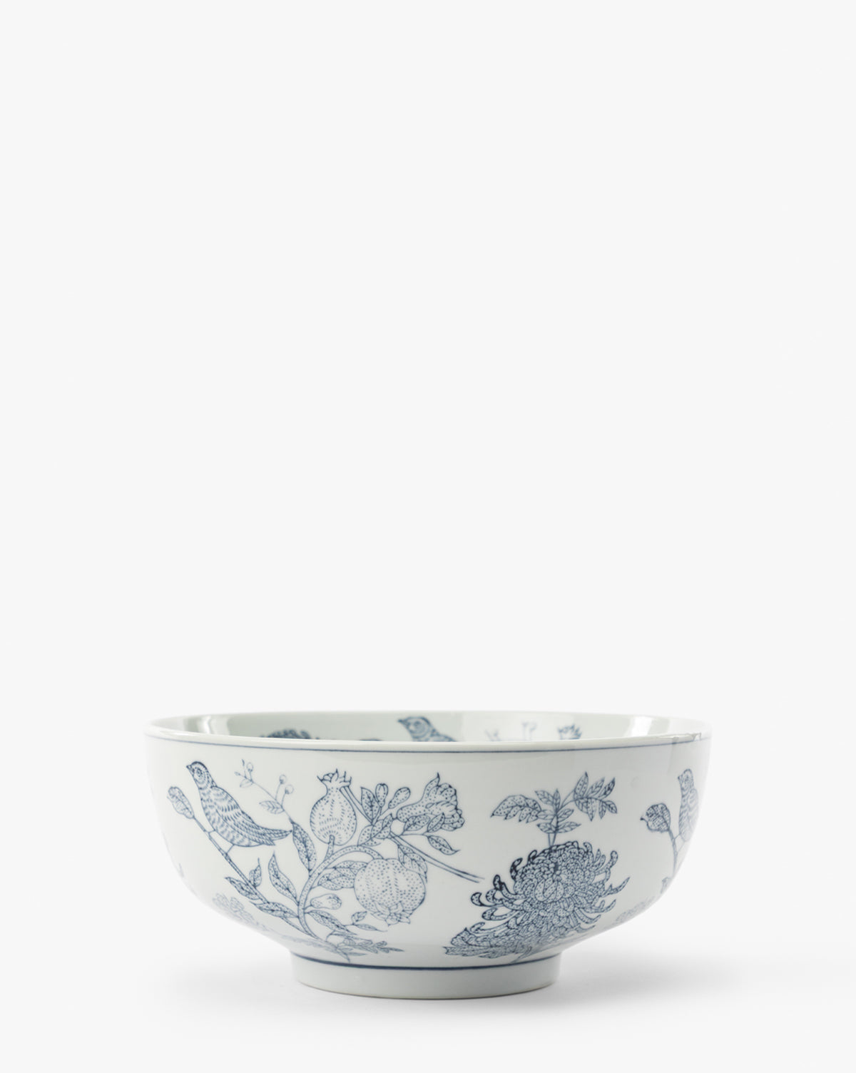 Hand Stamped Botanical Bowl features delicate blue bird motifs and floral patterns on white porcelain, creating an elegant contrast against a plain background, by Vendixs