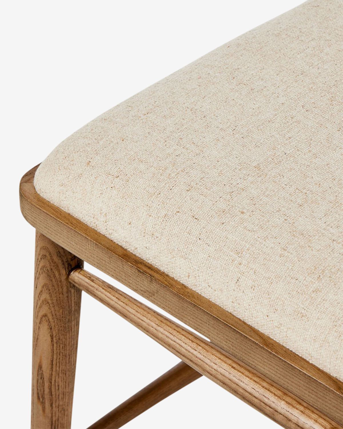Close-up of the Harper Dining Chair, made from solid ash with a light beige upholstered seat cushion. The image showcases its smooth wood grain and modern design against a white background, by Vendixs