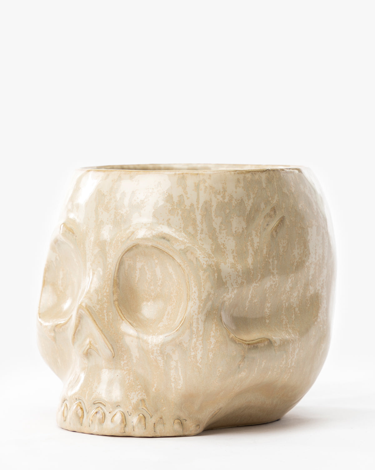 The Haunting Skull Vase is a beige ceramic piece featuring detailed eye sockets, nose, and teeth, shown against a white background—ideal as a statement decor item or for unique Halloween styling, by Vendixs