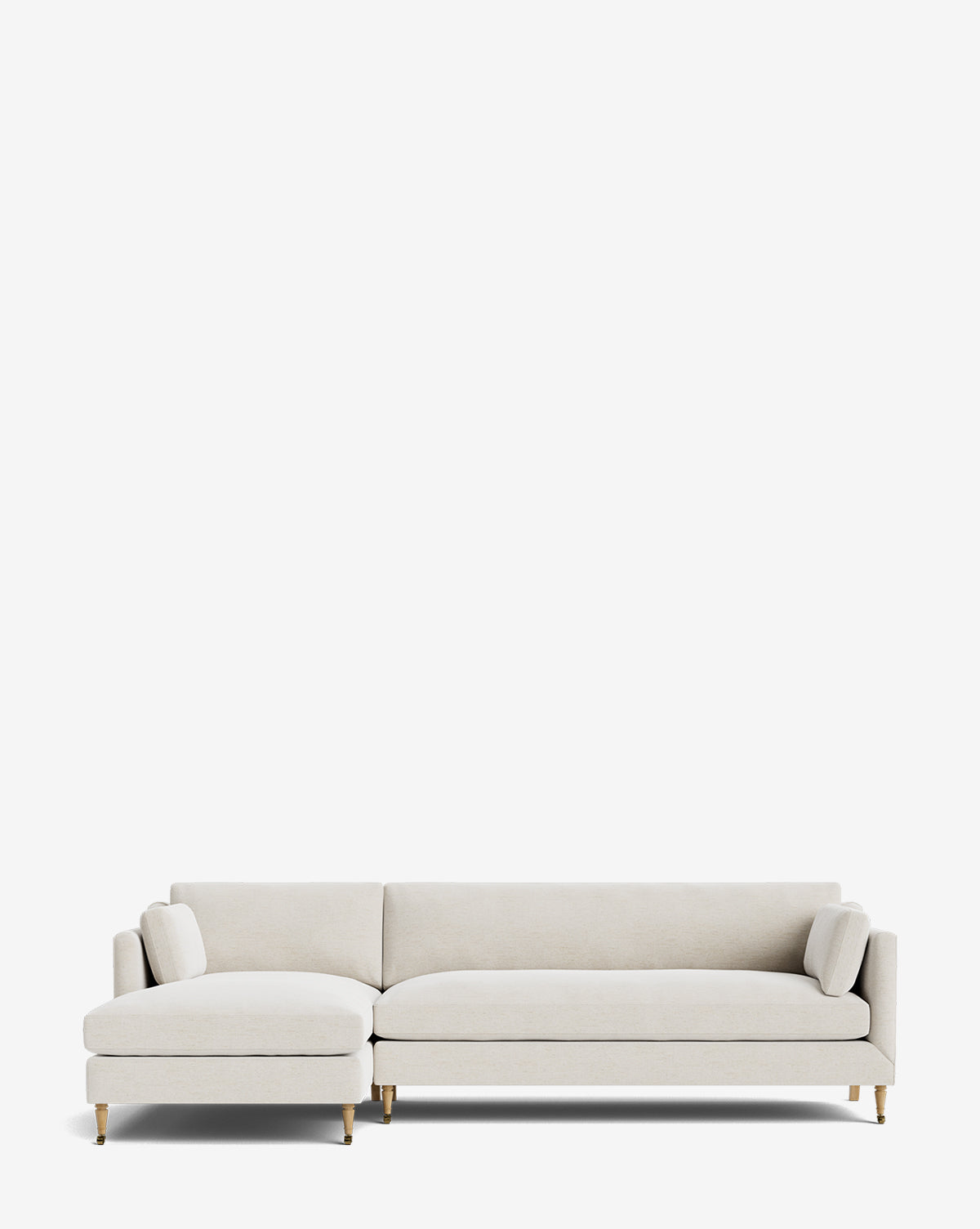 The Haverford Upholstered Left Chaise Sectional by Rowe Fine Furniture features light beige upholstery, slim cushions, and gold-capped wooden legs, shown against a plain white background. Vendixs