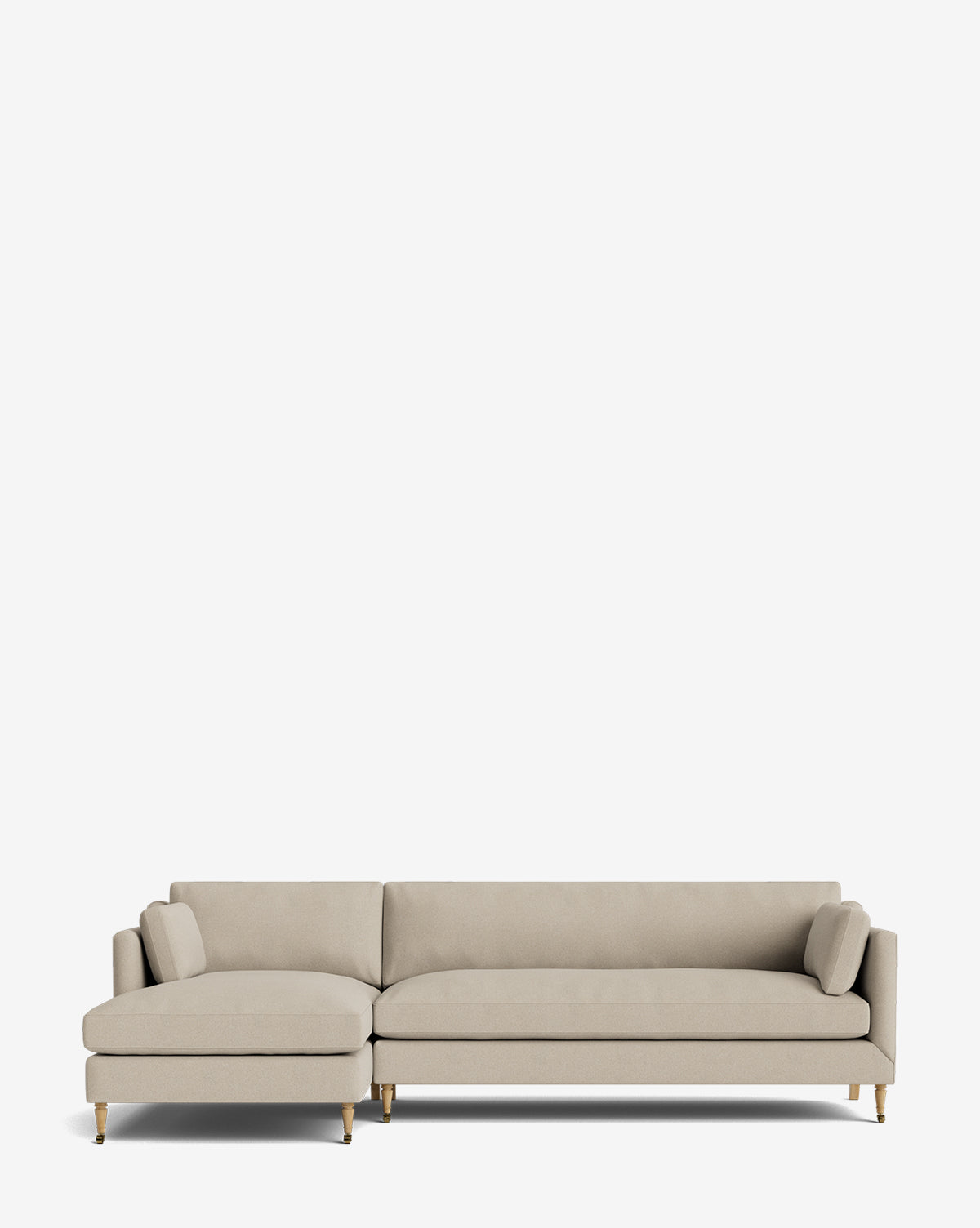 The Haverford Upholstered Left Chaise Sectional features light beige fabric, a left-side chaise, slim gold legs, and two cylindrical pillows, shown against a plain white background by Vendixs