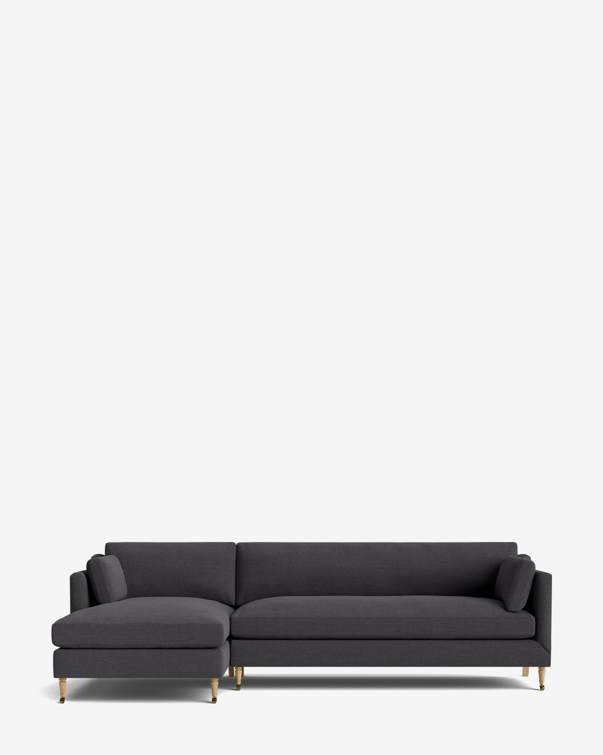 The Haverford Upholstered Left Chaise Sectional by Rowe Fine Furniture features a modern dark gray design, gold-tipped legs, and two matching cylindrical cushions on each end. Shown against a plain white background. Vendixs
