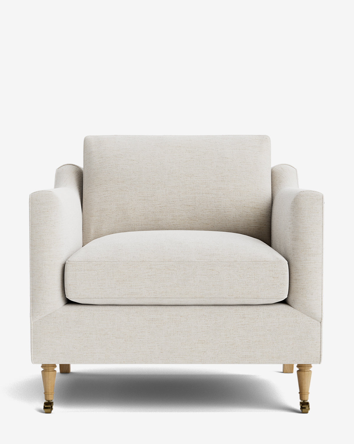 The Haverford Upholstered Lounge Chair in beige features a boxy shape, plush seat and back cushions, straight arms, and light wooden legs with front brass casters, shown against a plain white background by McGee & Co.