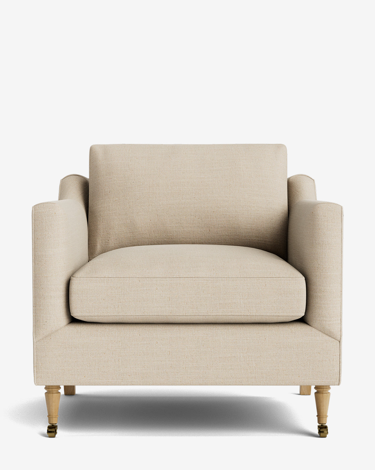 The Haverford Upholstered Lounge Chair is a beige handcrafted lounge chair with square cushions, straight armrests, and light wooden legs with small brass wheels on the front, shown against a plain white background by McGee & Co.