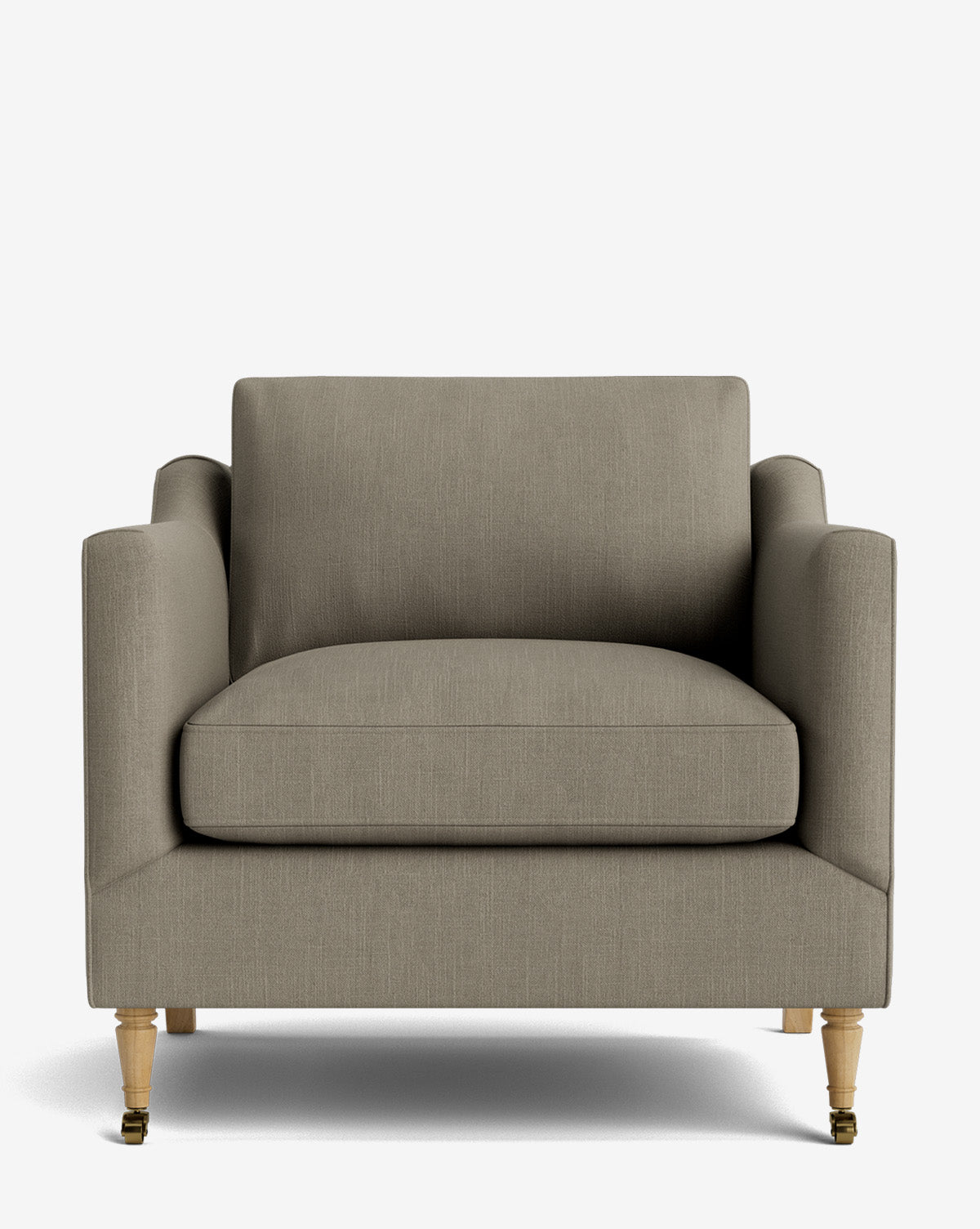 The Haverford Upholstered Lounge Chair features a modern taupe fabric, boxy silhouette, wooden legs, and front brass caster wheels, displayed against a plain white background by McGee & Co.