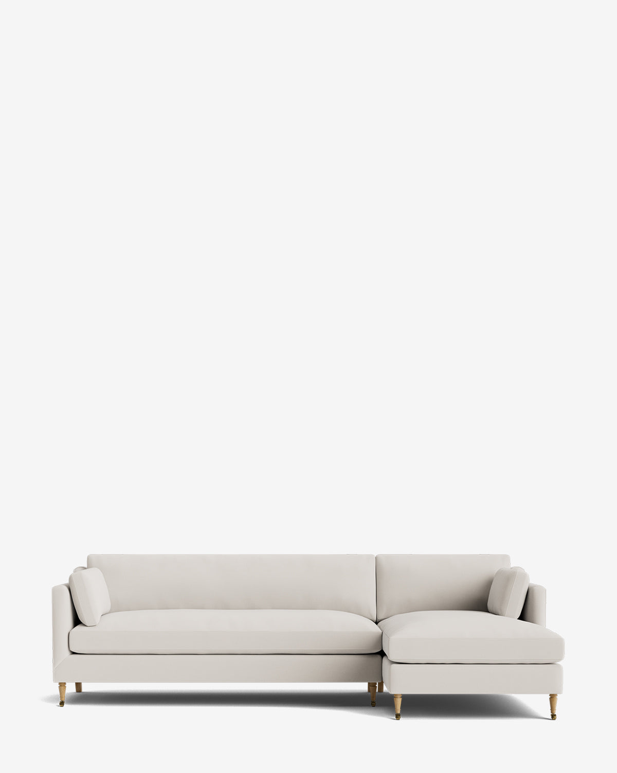 The Rowe Fine Furniture Haverford Upholstered Right Chaise Sectional features modern light gray upholstery, gold-capped wooden legs, and includes two matching cylindrical pillows, pictured against a plain white background. Vendixs