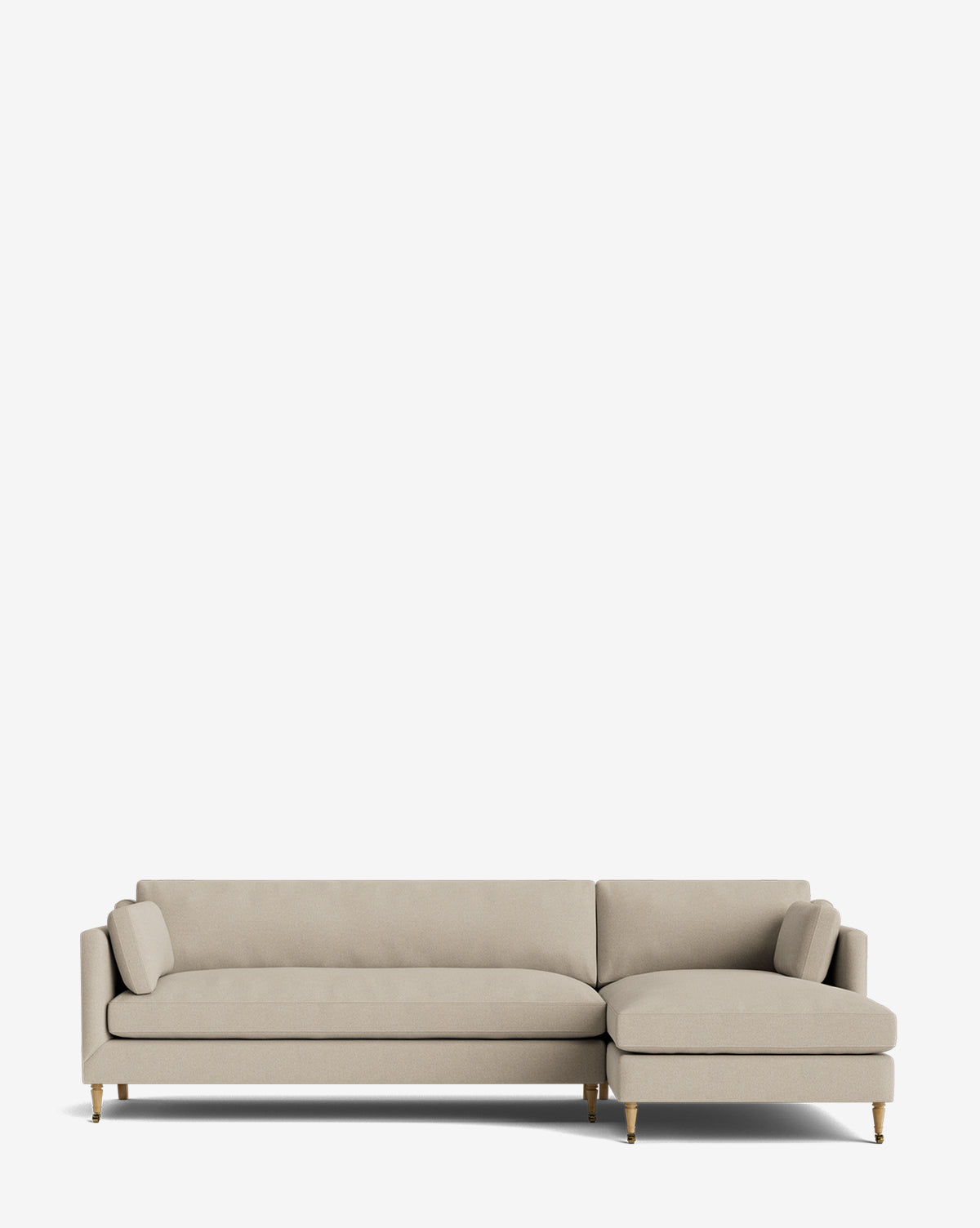 The Haverford Upholstered Right Chaise Sectional 113 in light beige features slim arms, angled wooden legs, two bolster pillows, and a right-side chaise lounge—an elegant made-to-order piece set against a plain white background by Vendixs