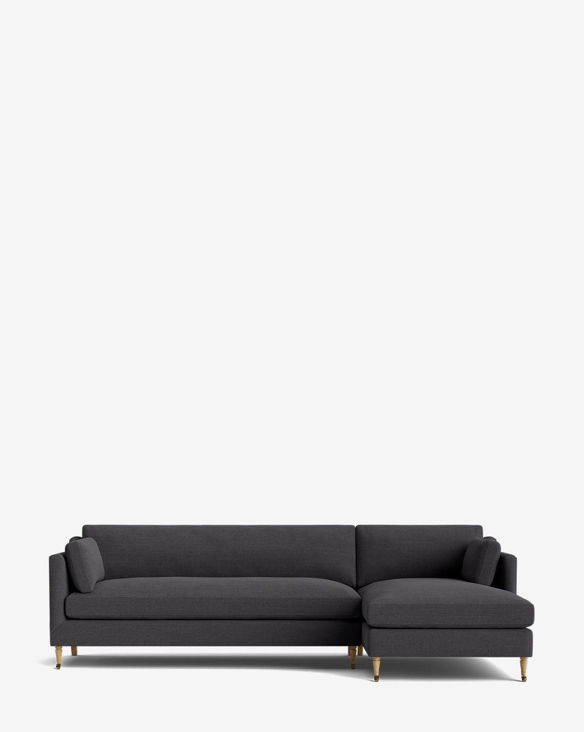 A modern dark gray Haverford Upholstered Right Chaise Sectional by Rowe Fine Furniture, featuring slim armrests, two cylindrical cushions, and wooden legs with gold-tone accents, sits against a plain light background for a stylish, customizable look by Vendixs