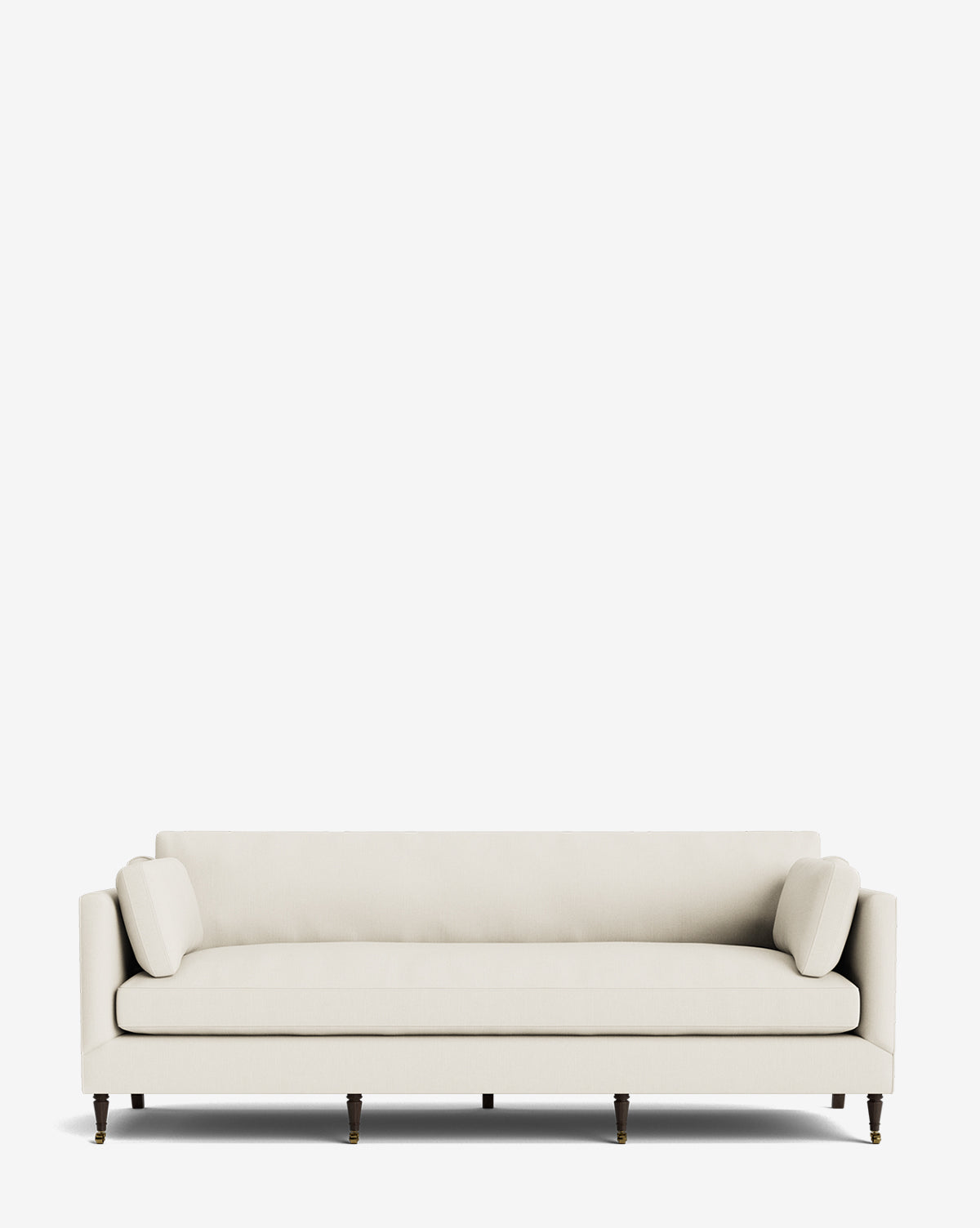 The Haverford Upholstered Sofa 90 is a modern cream sofa featuring low arms, two cylindrical side cushions, and six dark wood legs, shown against a plain white background by Vendixs