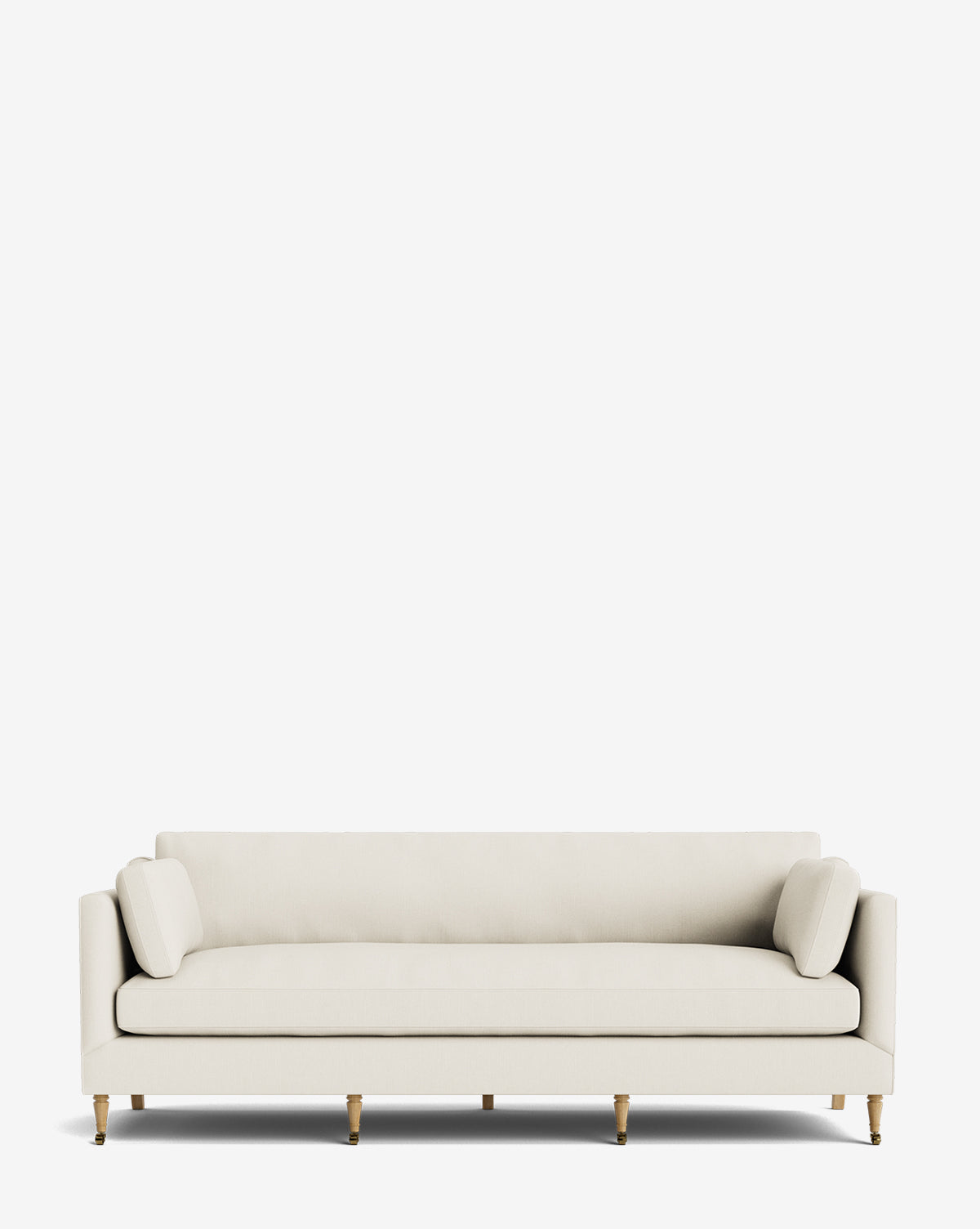 The Haverford Upholstered Sofa 90 is a modern, light beige sofa with a low back, two cylindrical side pillows, and wooden legs, shown against a plain white background by McGee & Co.