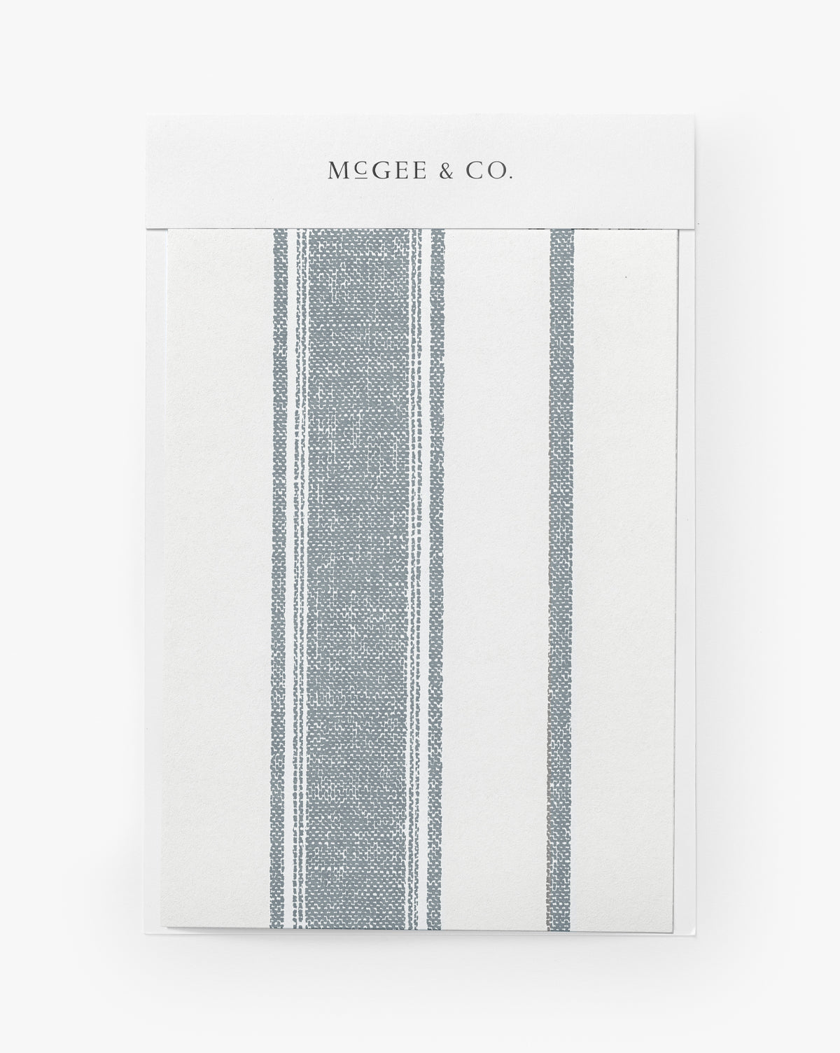 The Hawes Stripe Wallpaper Swatch features a simple vertical stripe design on the front, reminiscent of woven-inspired patterns and labeled as Hawes Stripe Wallpaper, by Vendixs