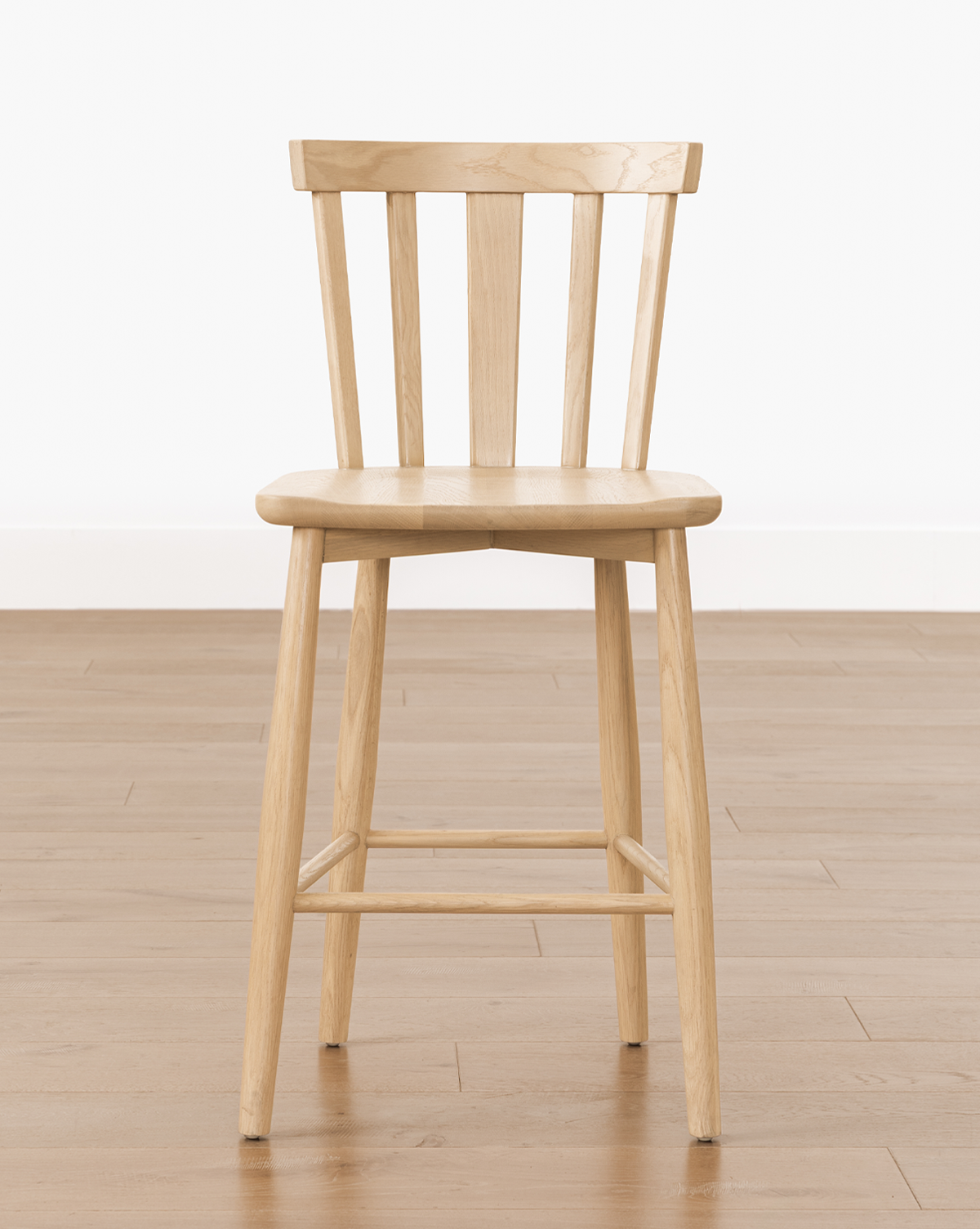 It sits on a light wood floor against a plain white wall, by Vendixs