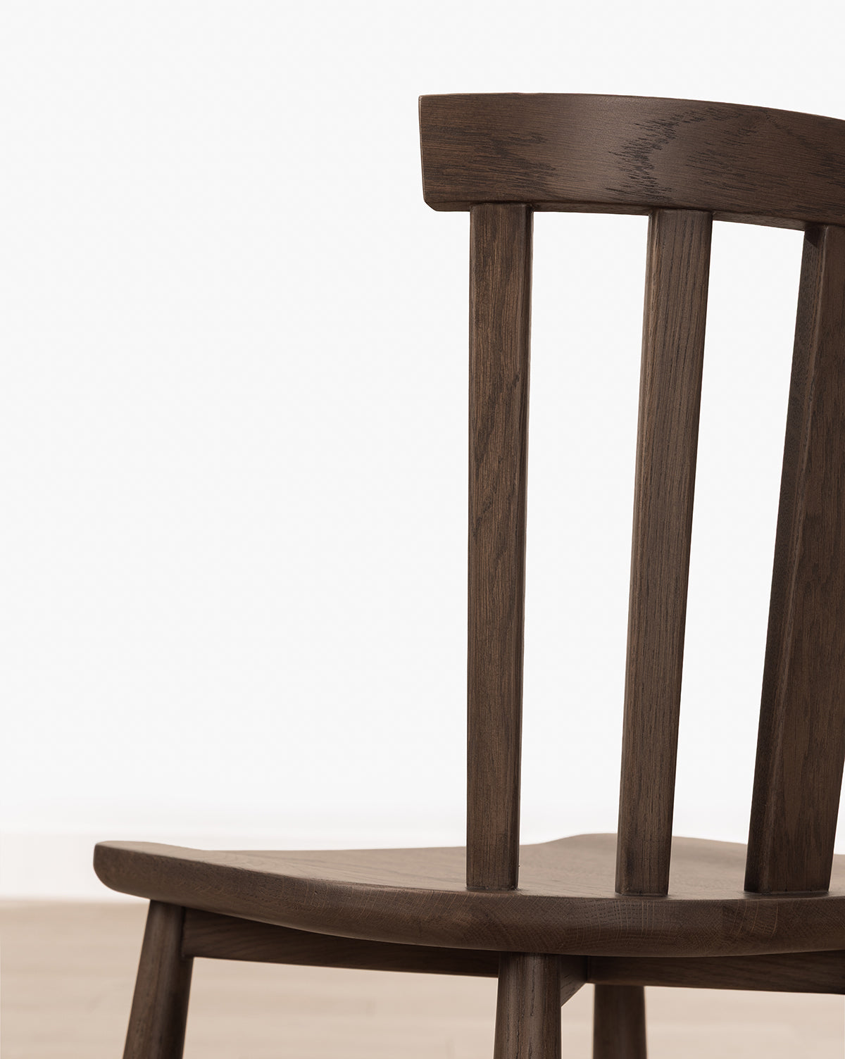 A close-up of the Hemingway Stool highlights its solid wood frame, dark backrest with vertical slats, and seat, all set against a plain white background—ideal for placing by kitchen counters, by Vendixs