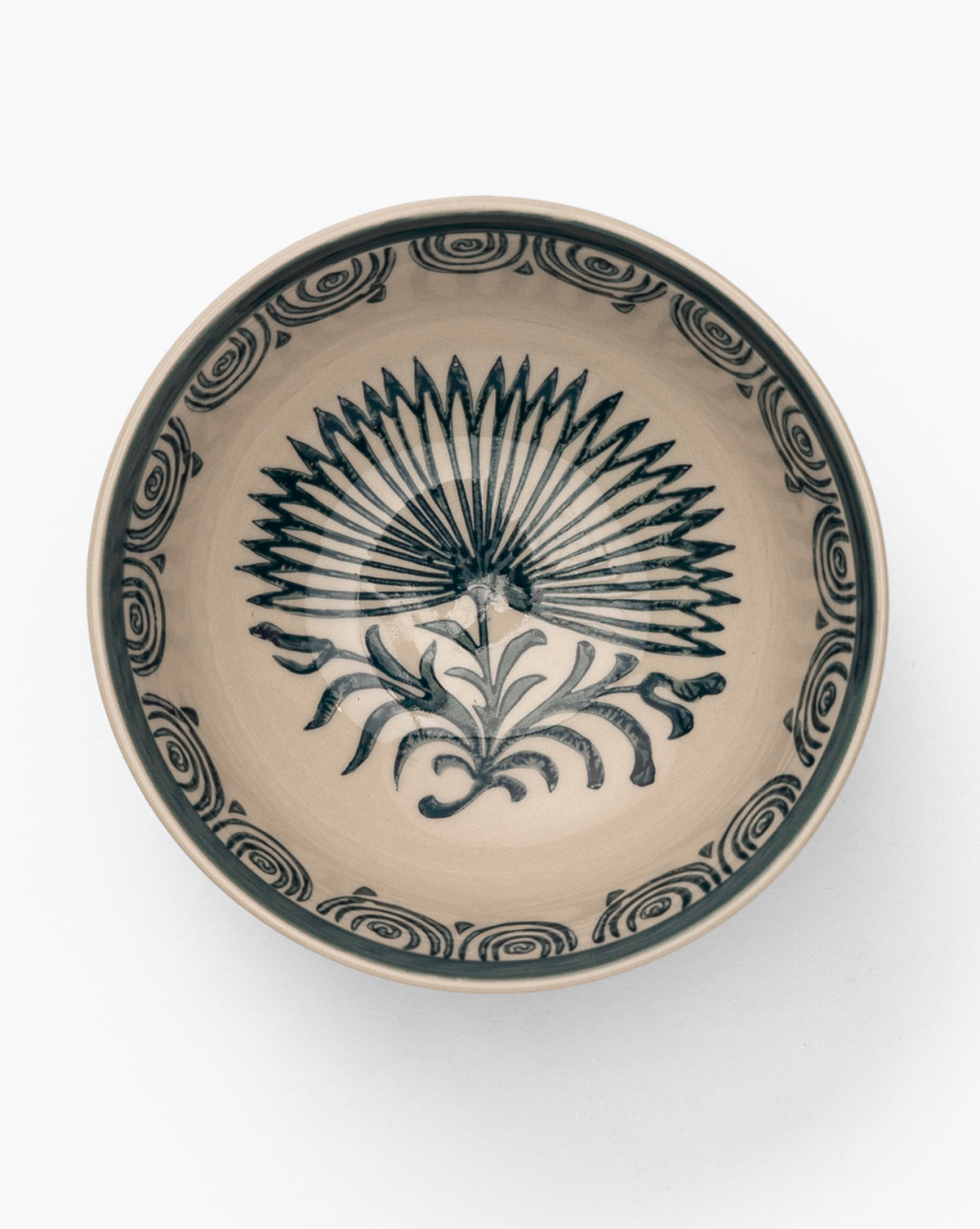 The Mattia Hand-Painted Bowl is a round glazed stoneware bowl with a beige base and dark blue fan-like center, plus floral swirl motifs around the rim, by Vendixs