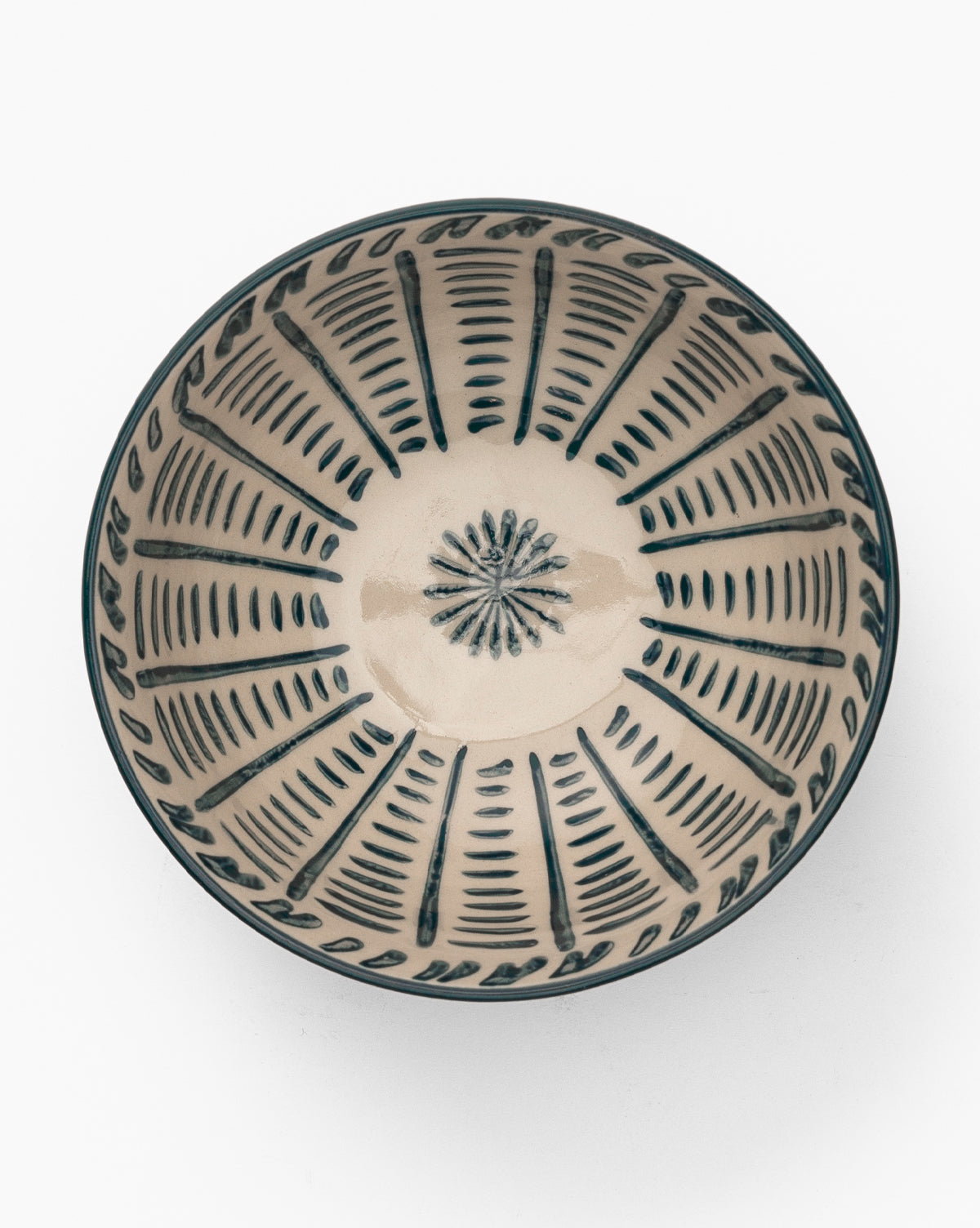 The Mattia Hand-Painted Bowl is a round, glazed stoneware piece with a cream-colored base and bold blue geometric patterns radiating from the center to the rim, by Vendixs