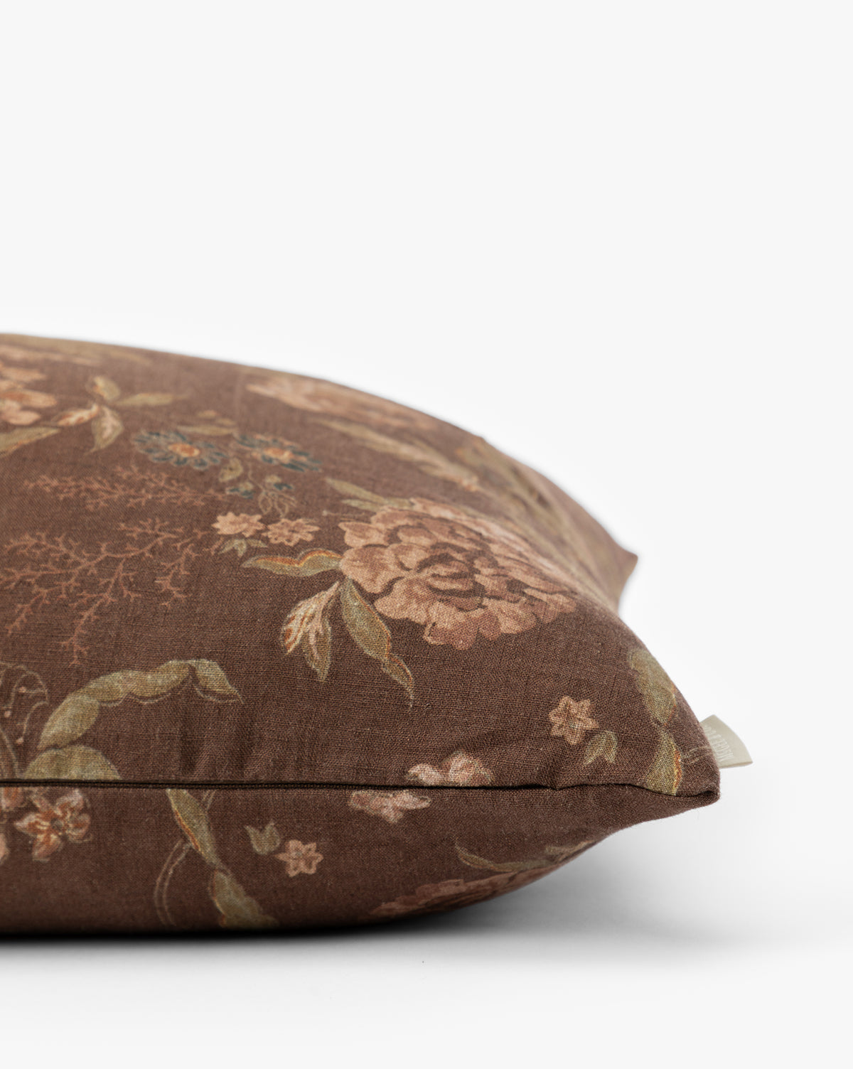 A close-up of the Hestercombe Pillow Cover, featuring a brown, vintage-inspired floral design in muted pink, green, and beige tones, displayed against a plain white background by Vendixs