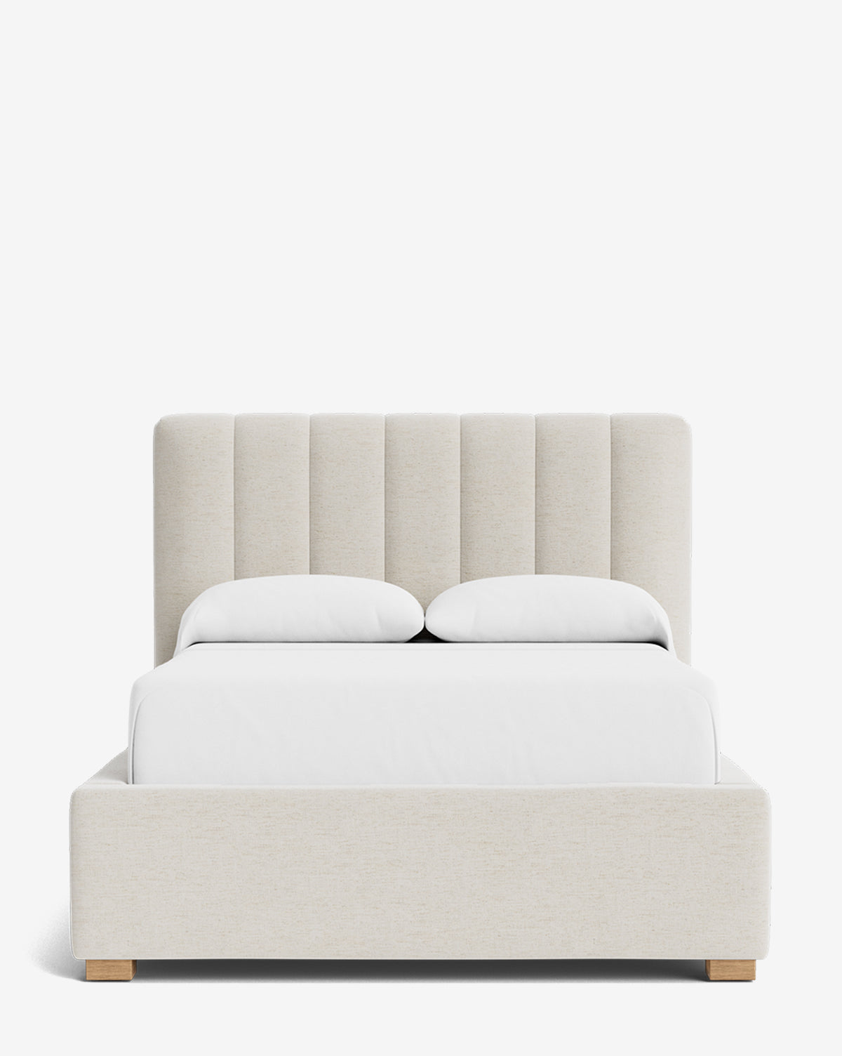 The Hoffman Bed Low Headboard is a modern upholstered bed with a customizable beige headboard and frame featuring vertical tufting, wooden legs, white bedding, and two pillows, set against a plain white background, by McGee & Co.