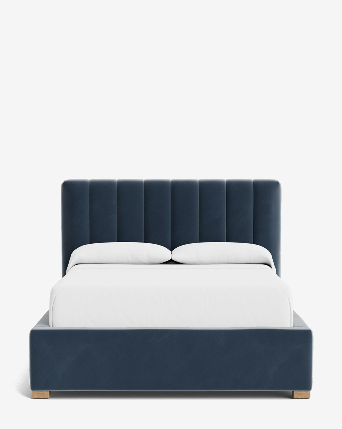 The Hoffman Bed Low Headboard is a modern upholstered bed with a customizable navy blue low headboard and frame, dressed in white bedding and two white pillows, shown against a plain white background, by McGee & Co.