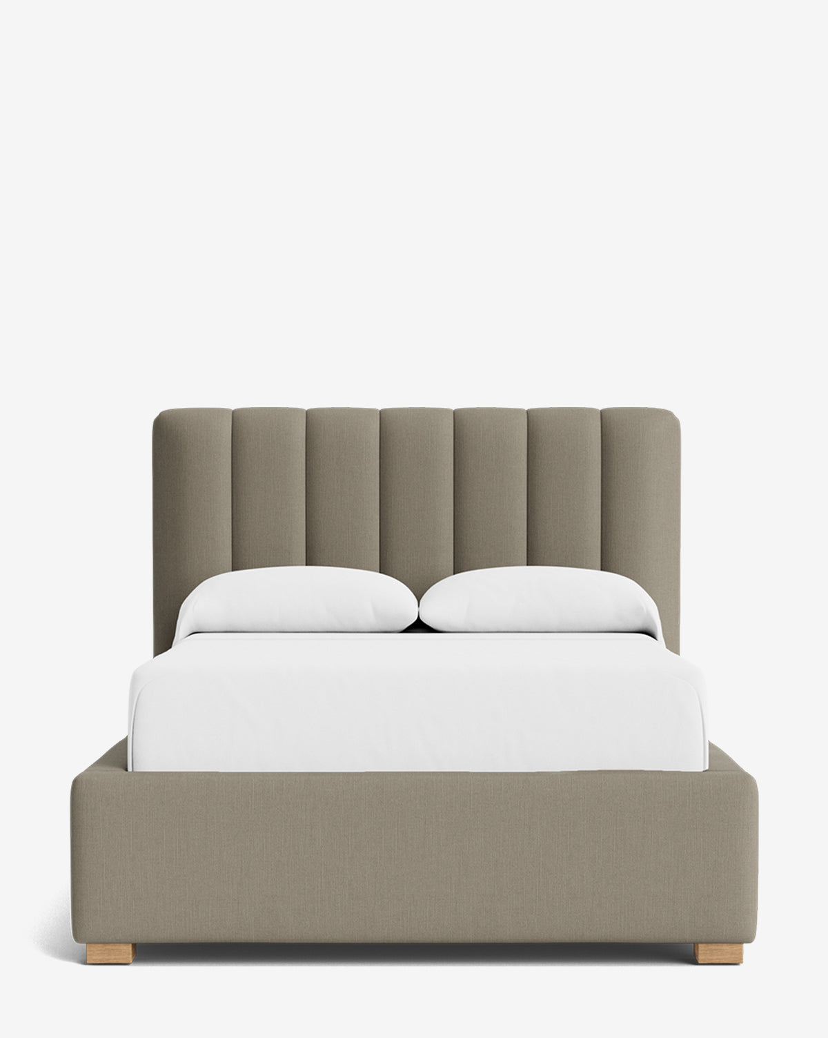 The Hoffman Bed Low Headboard is a modern beige upholstered bed with a customizable vertical headboard, two white pillows, and a white duvet on short wooden legs, shown against a plain white background by McGee & Co.