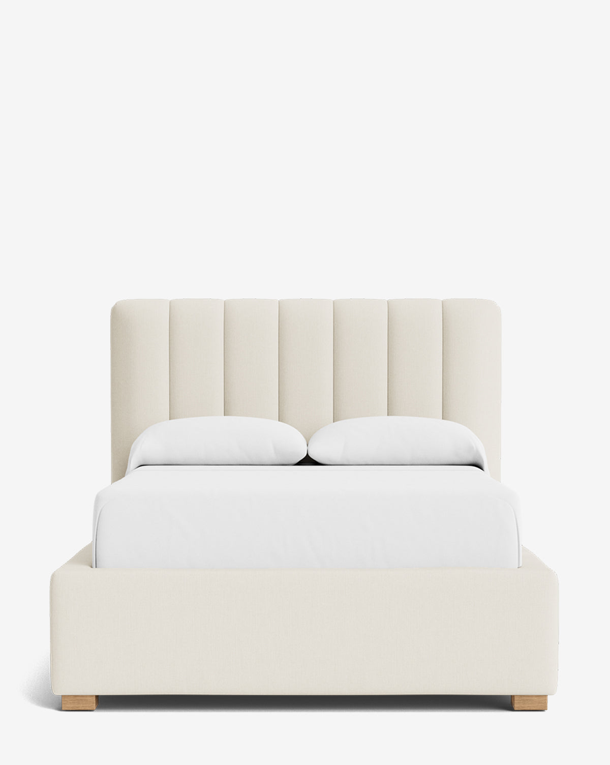 Front view of the Hoffman Bed Low Headboard, a modern upholstered bed with a low, customizable cream headboard, white bedding, and two pillows on short wooden legs set against a plain white background by McGee & Co.