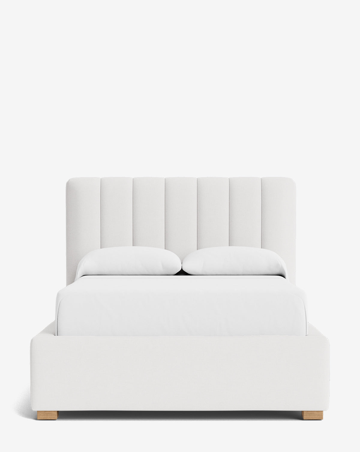 The Hoffman Bed Low Headboard is a modern white upholstered bed with a vertically paneled, customizable low headboard, two pillows, and wooden legs, displayed on a plain white background by Vendixs