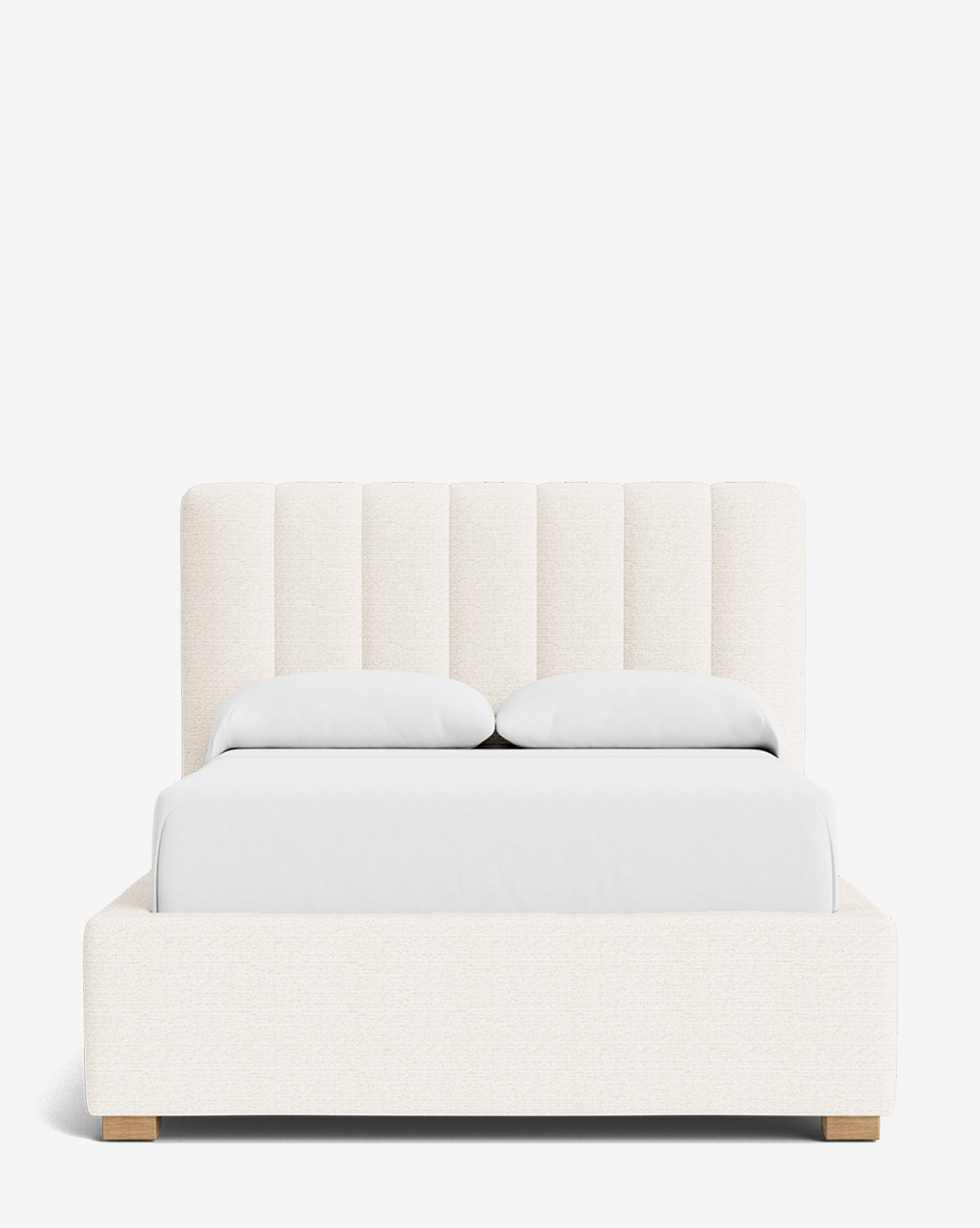 The Hoffman Bed Low Headboard features a modern, vertically channeled customizable headboard in cream fabric, white bedding, and low wooden legs, displayed against a plain white background by McGee & Co.