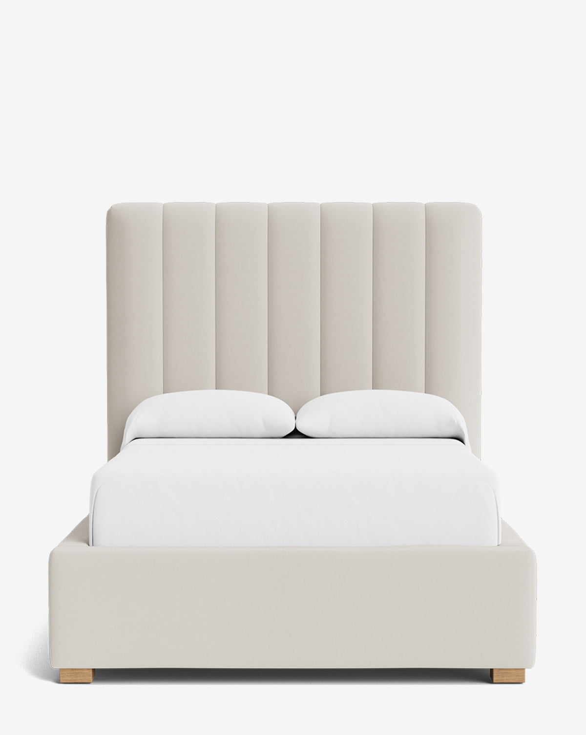 The Hoffman Bed Tall Headboard features beige upholstery, a tall vertically channeled headboard, two white pillows, and a white bedspread on a plain white background. Customizable fabrics are available, by McGee & Co.