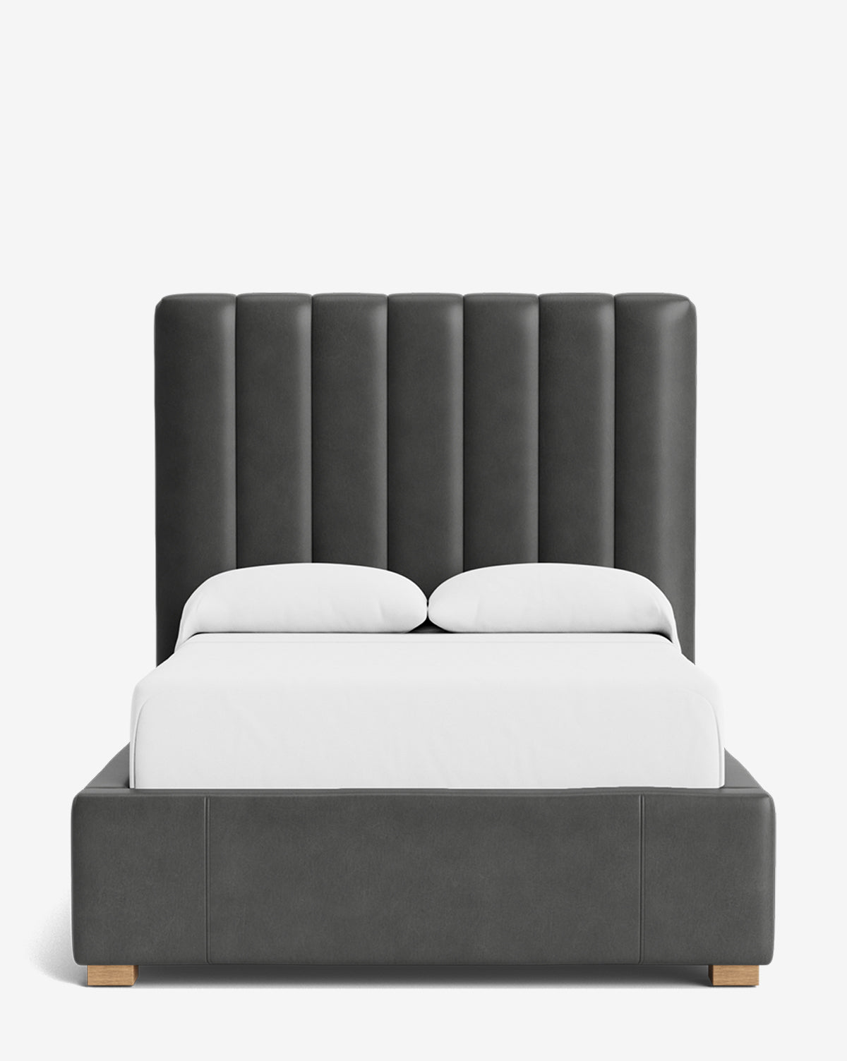 The Hoffman Bed Tall Headboard features a tall, vertically paneled dark gray upholstered headboard and matching base. Neatly made with white sheets and pillows, it appears against a white background. Customizable fabrics are available by McGee & Co.