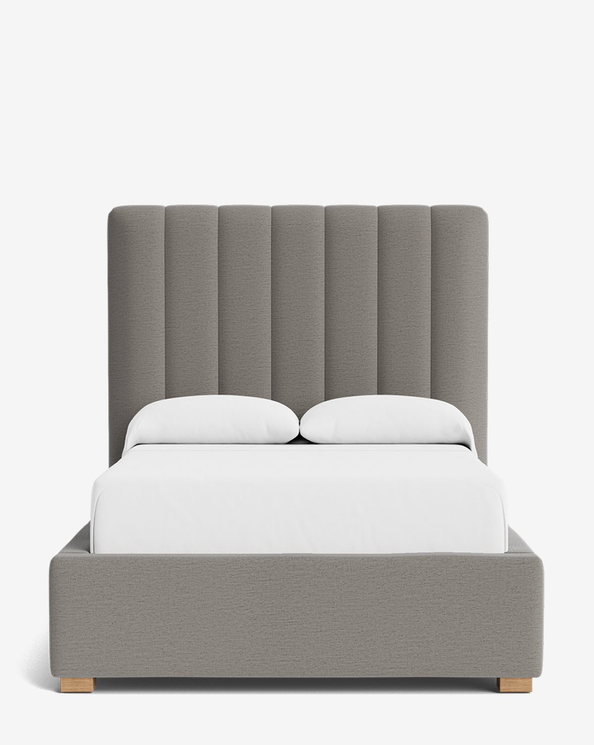 The Hoffman Bed Tall Headboard, shown in modern grey upholstery with vertical channel tufting and crisp white bedding against a plain white background, features customizable fabrics to personalize this elegant centerpiece, by Vendixs